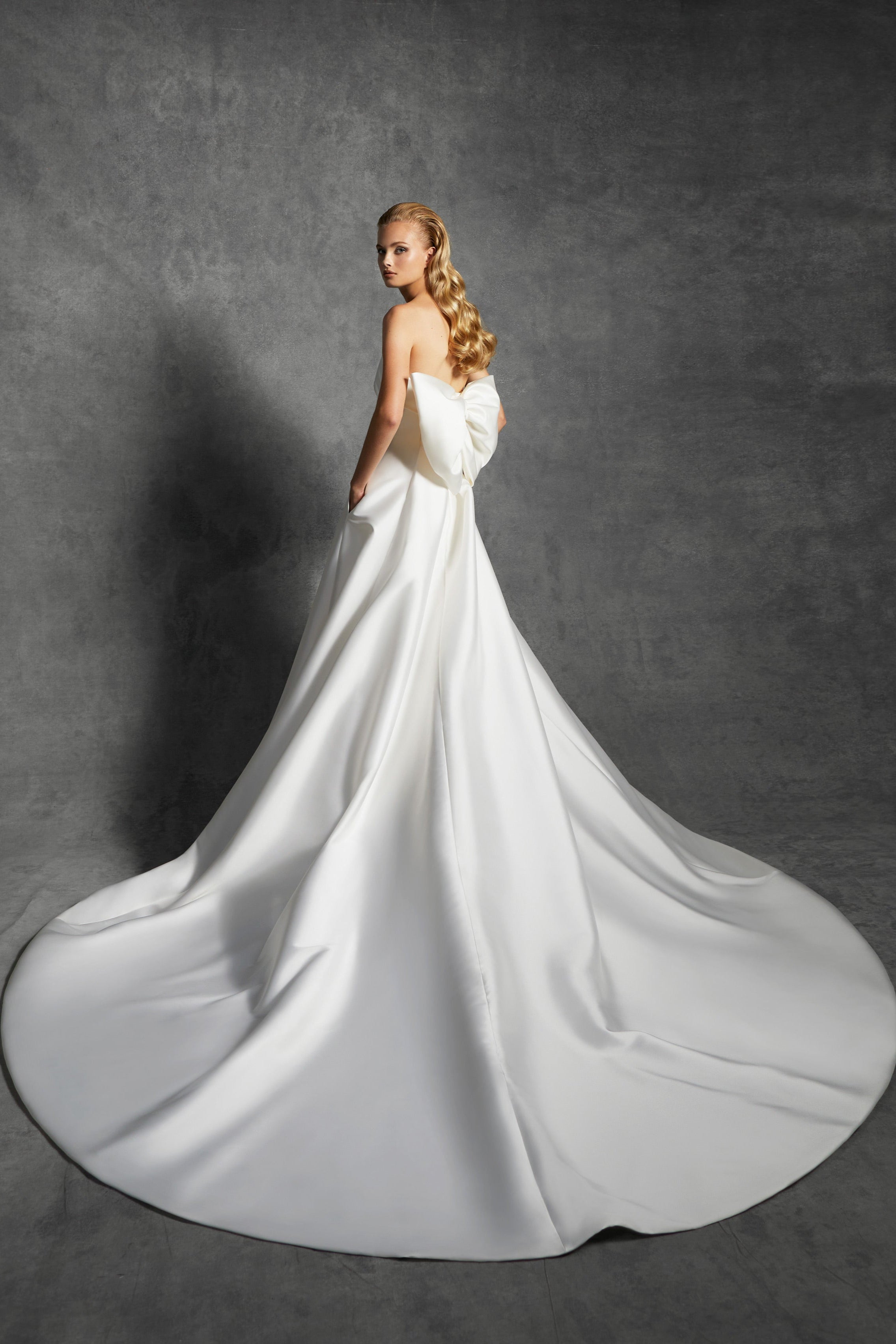 Graphic, strapless a-line dress with a clean band that leads way to an oversized signature viktor&rolf bow to create back interest