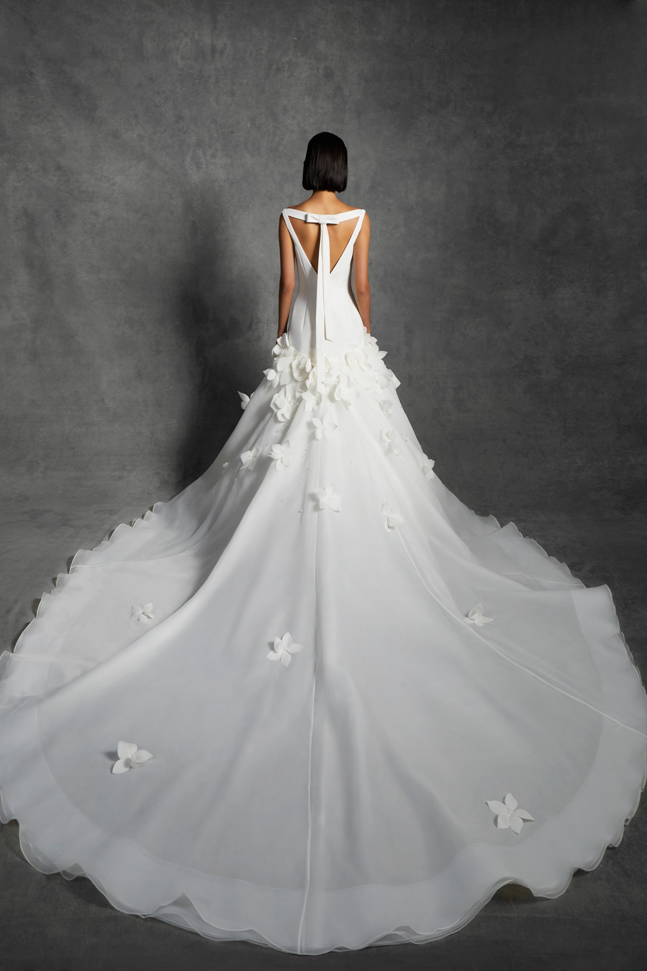 Chic mermaid silhouette with a clean crepe bodice that delicately sculpts the wearer's body