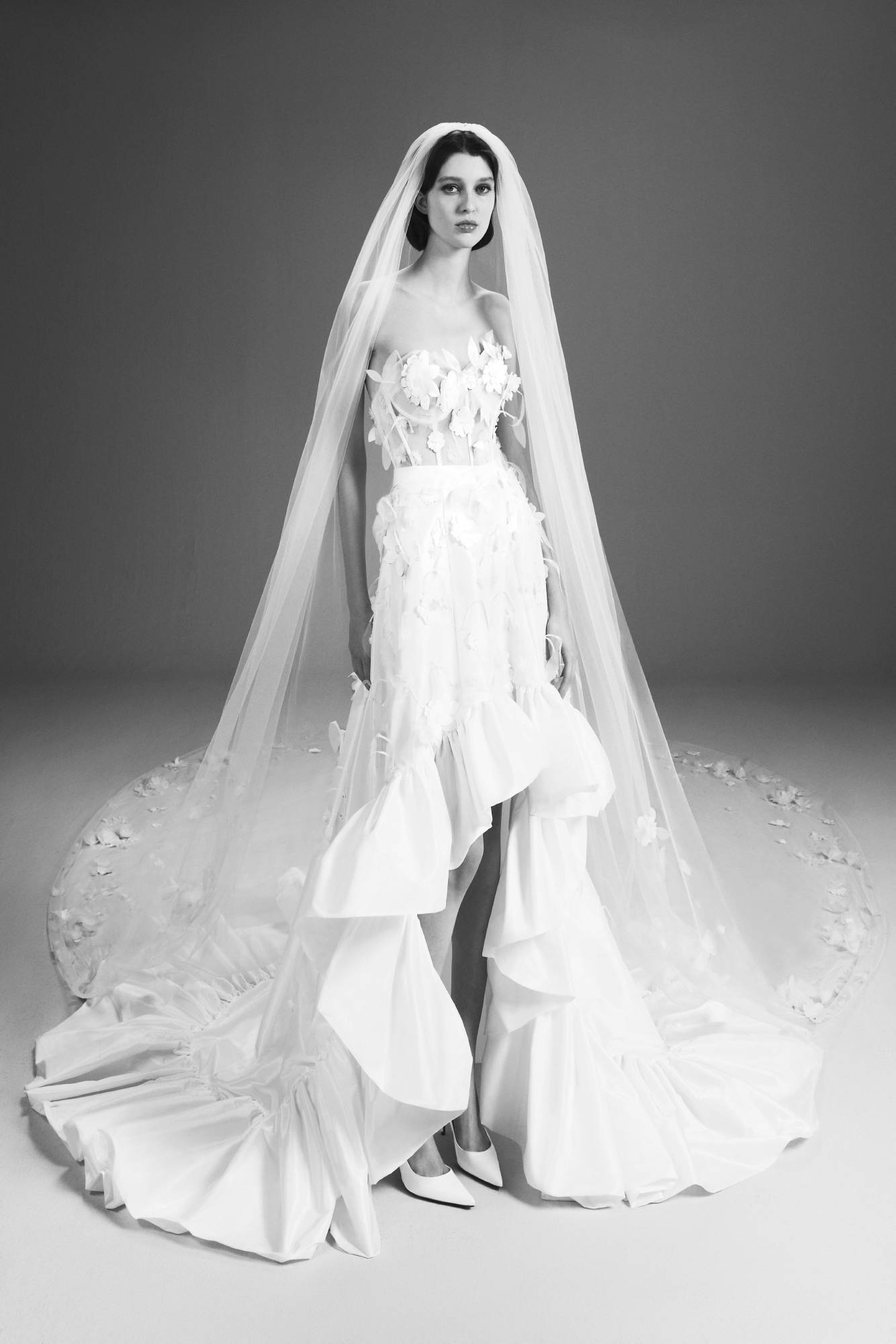 Viktor & Rolf Mariage Bridalwear Collection gown, floral applique bodice with voluminous ruffled skirt and delicate veil.