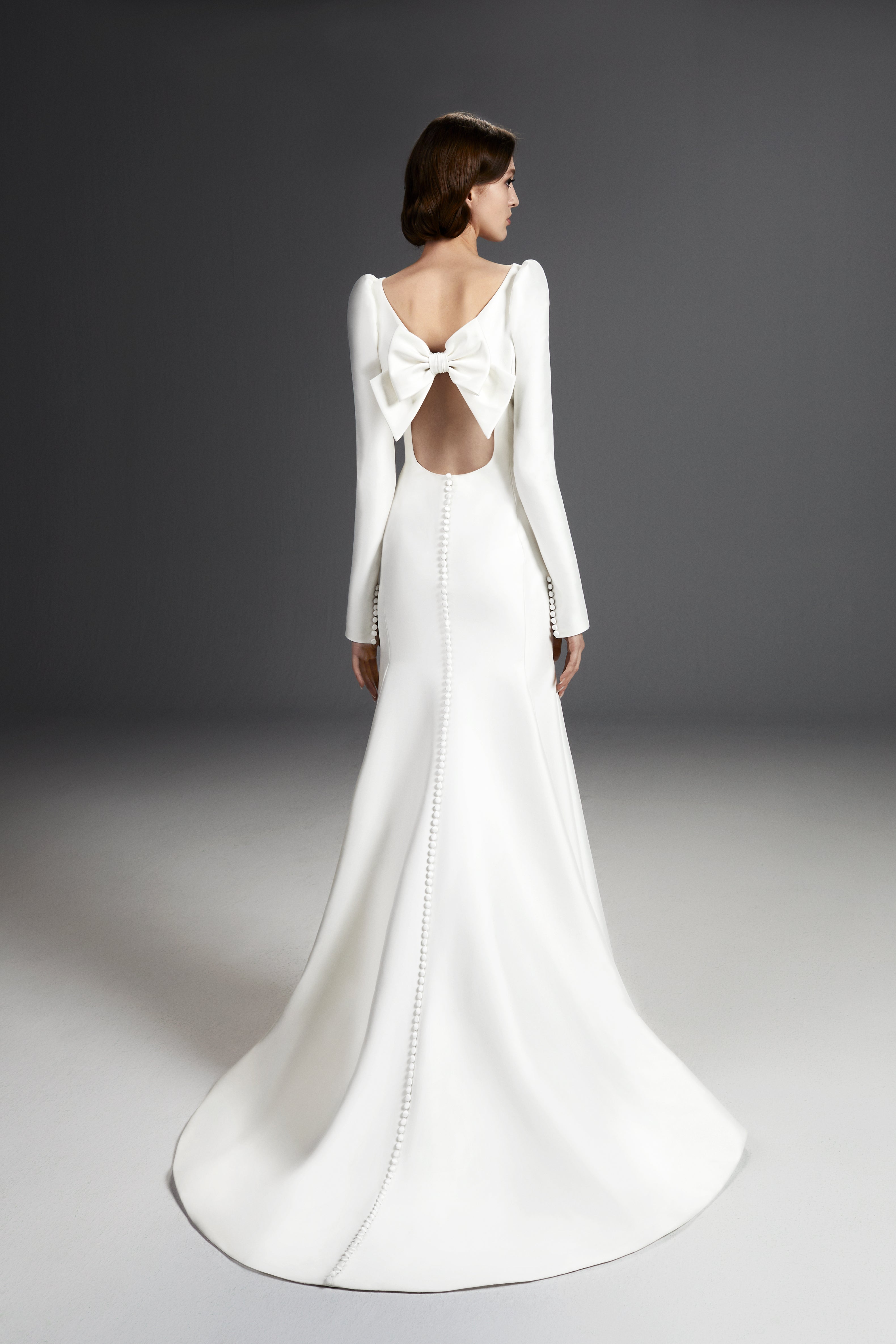 Viktor & Rolf Mariage Bridalwear Collection, sculpted column gown with elegant bow detail and exquisite buttoned back.