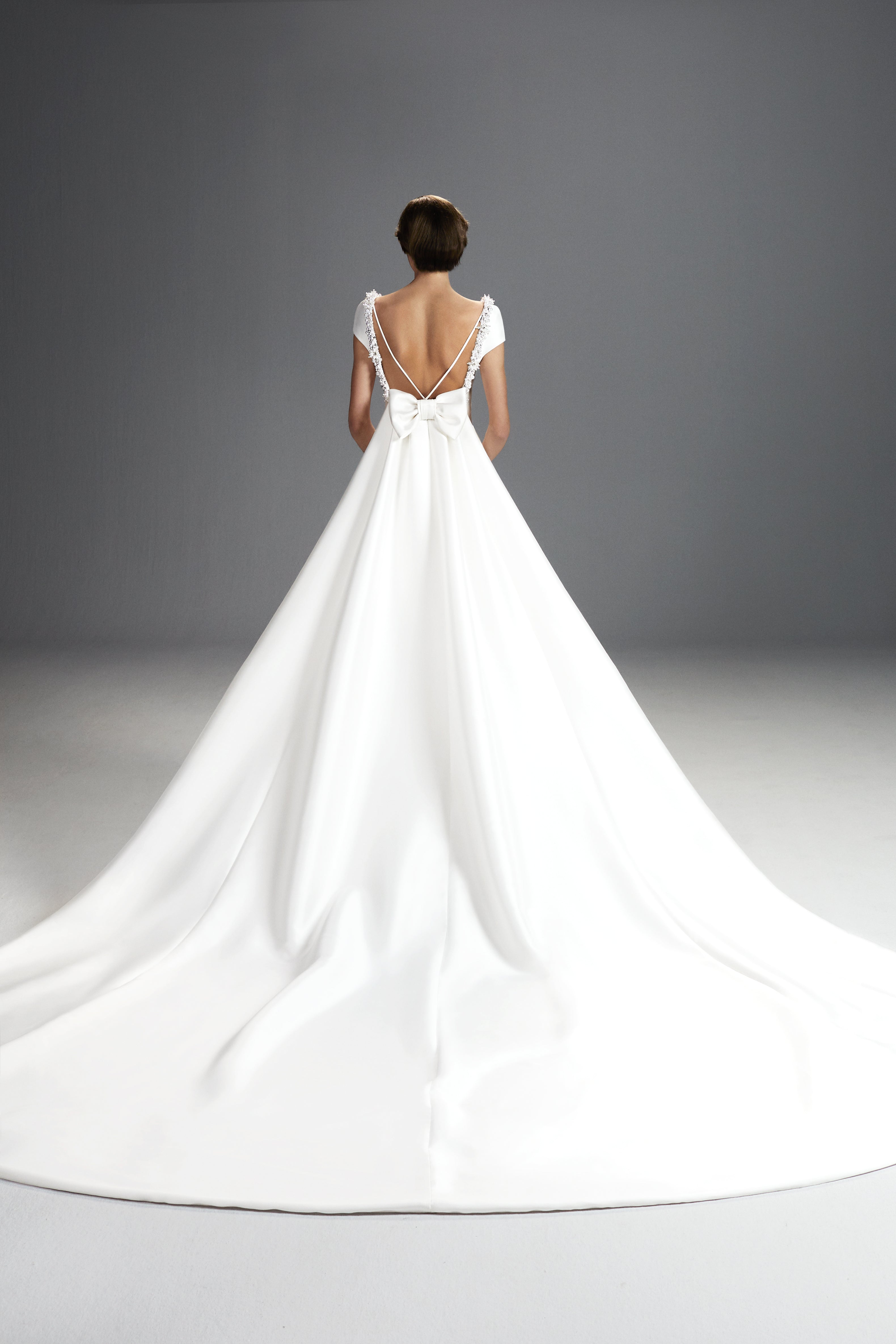 Viktor & Rolf Mariage Bridalwear Collection, Tales of Pearls Gown, elegant flow with back bow detail and couture design.
