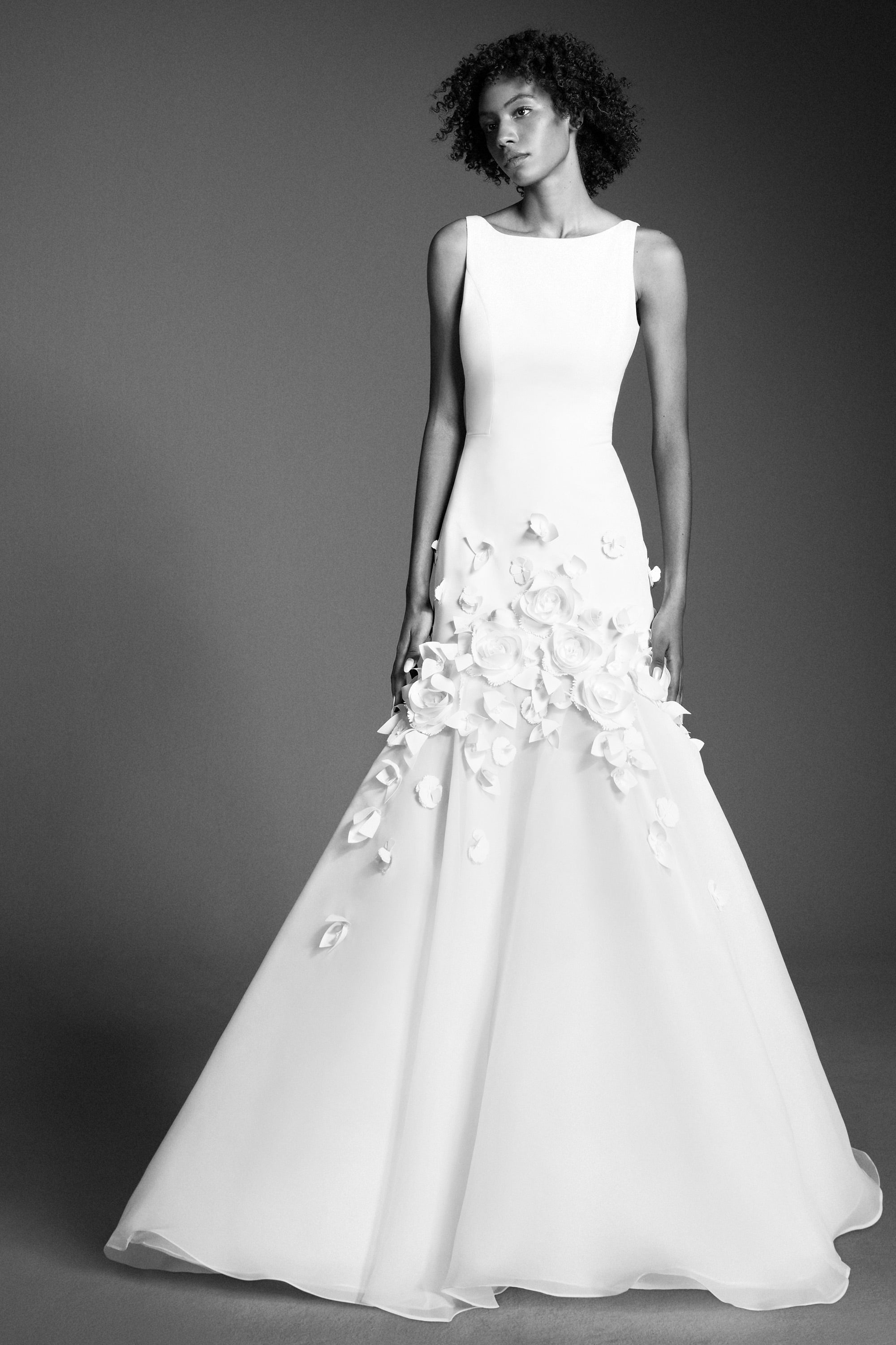 This refined mermaid gown, crafted from crepe with a slight stretch, perfectly molds to the wearer’s body before flaring out into a decadent train