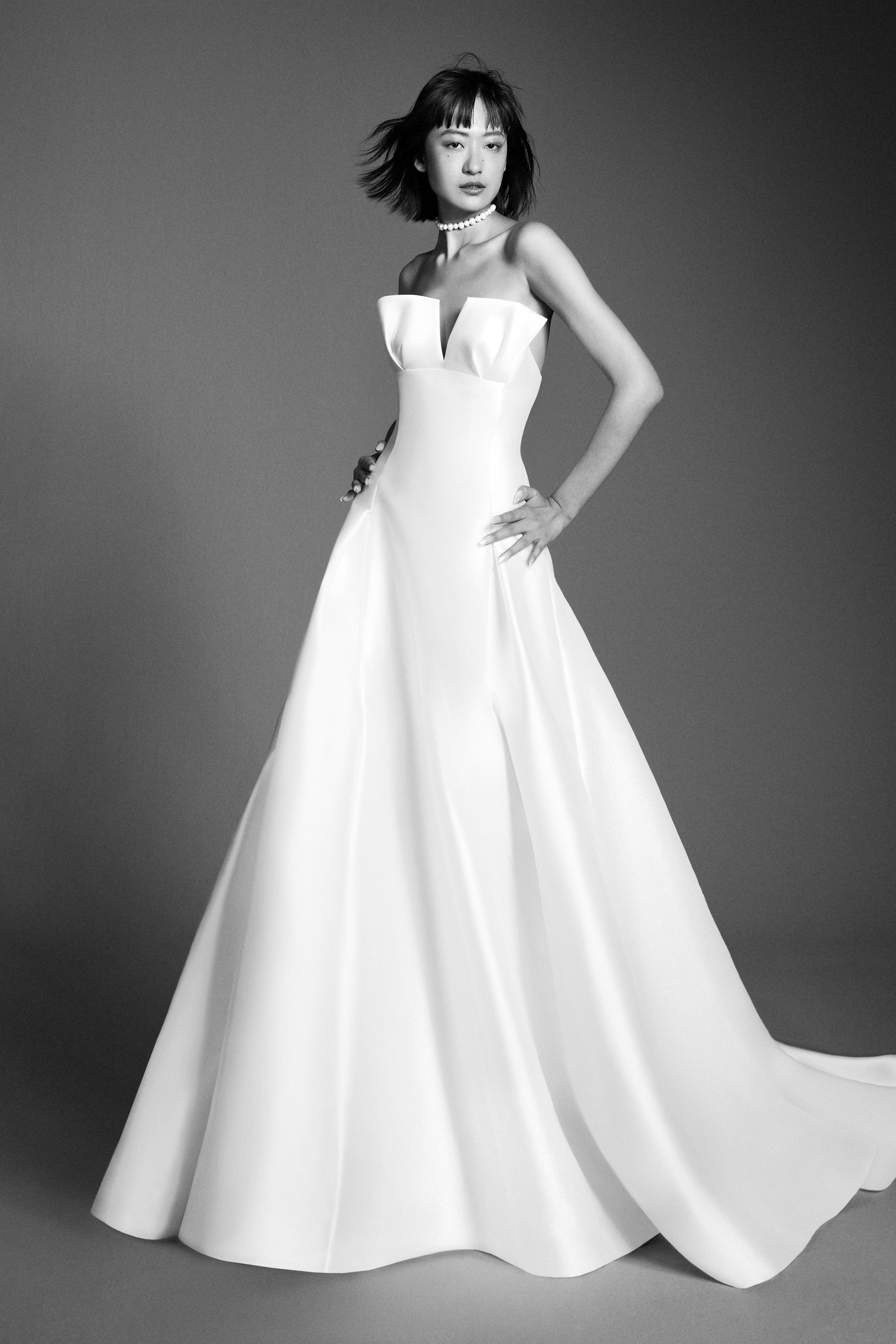 Chic a-line gown crafted out of mikado, perfectly molds to the body and flares out in a decadent train