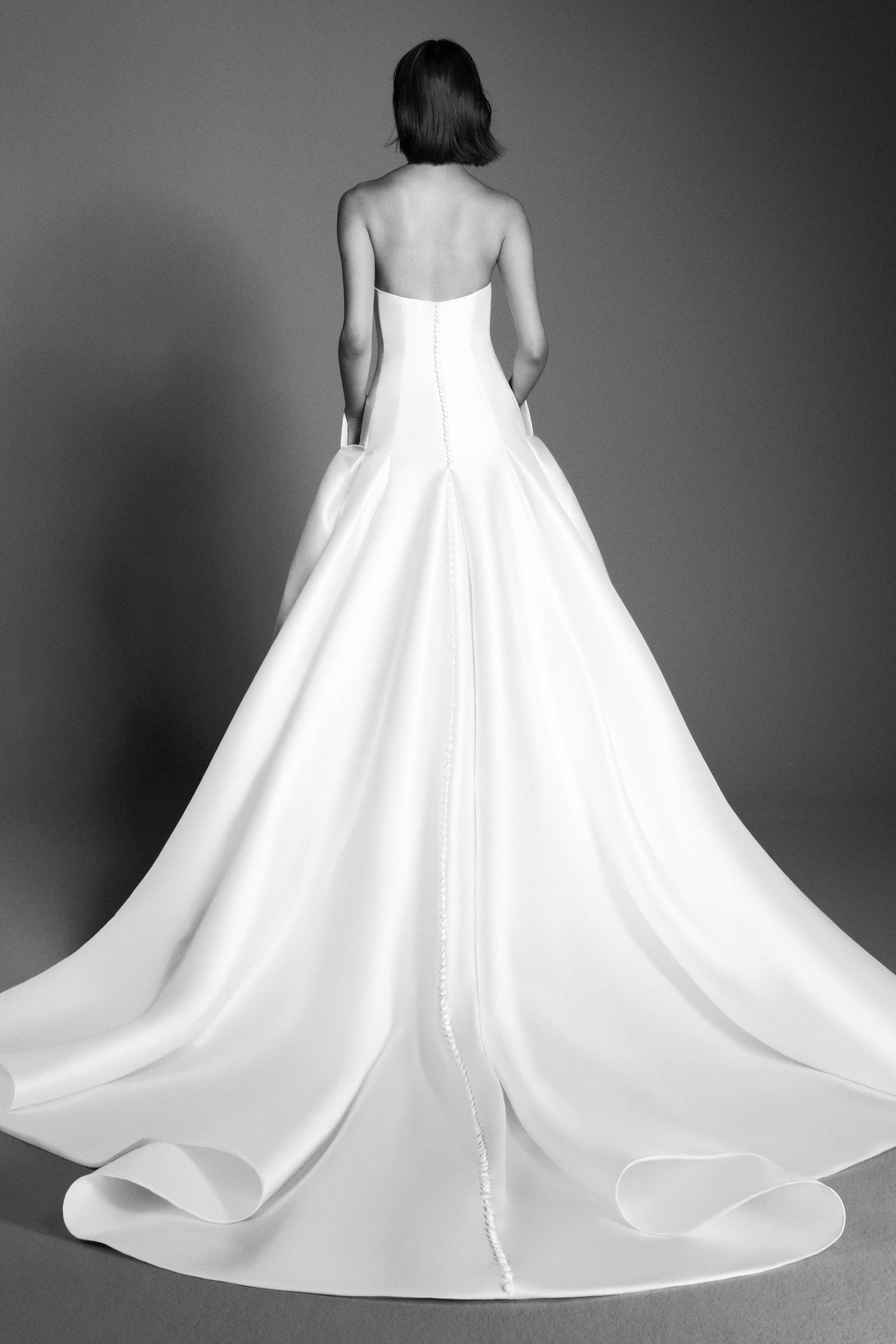 Chic a-line gown crafted out of mikado, perfectly molds to the body and flares out in a decadent train