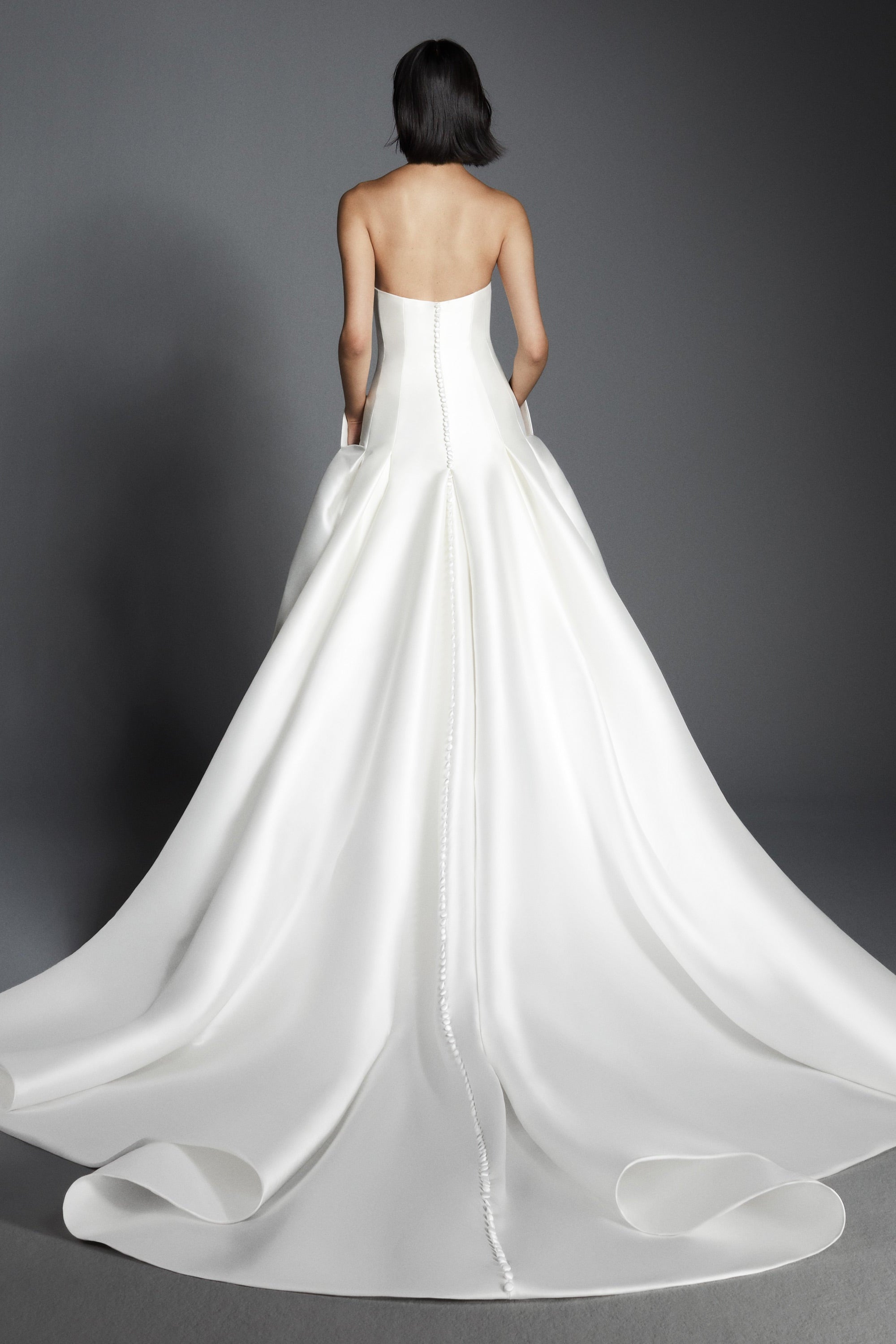 Chic a-line gown crafted out of mikado, perfectly molds to the body and flares out in a decadent train