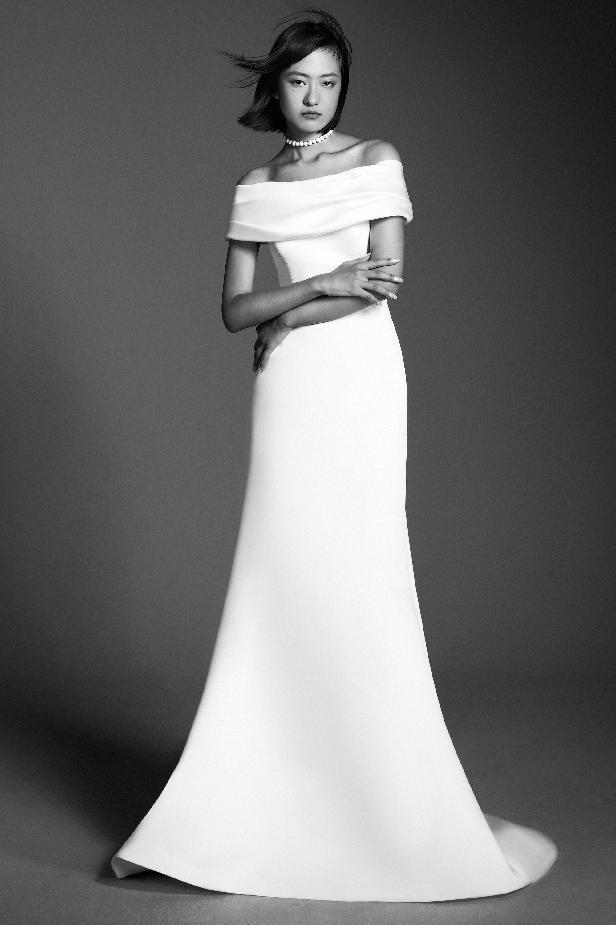 A charming mermaid gown, crafted out of satin, perfectly molds to the wearer’s body and flares out in a sweep train