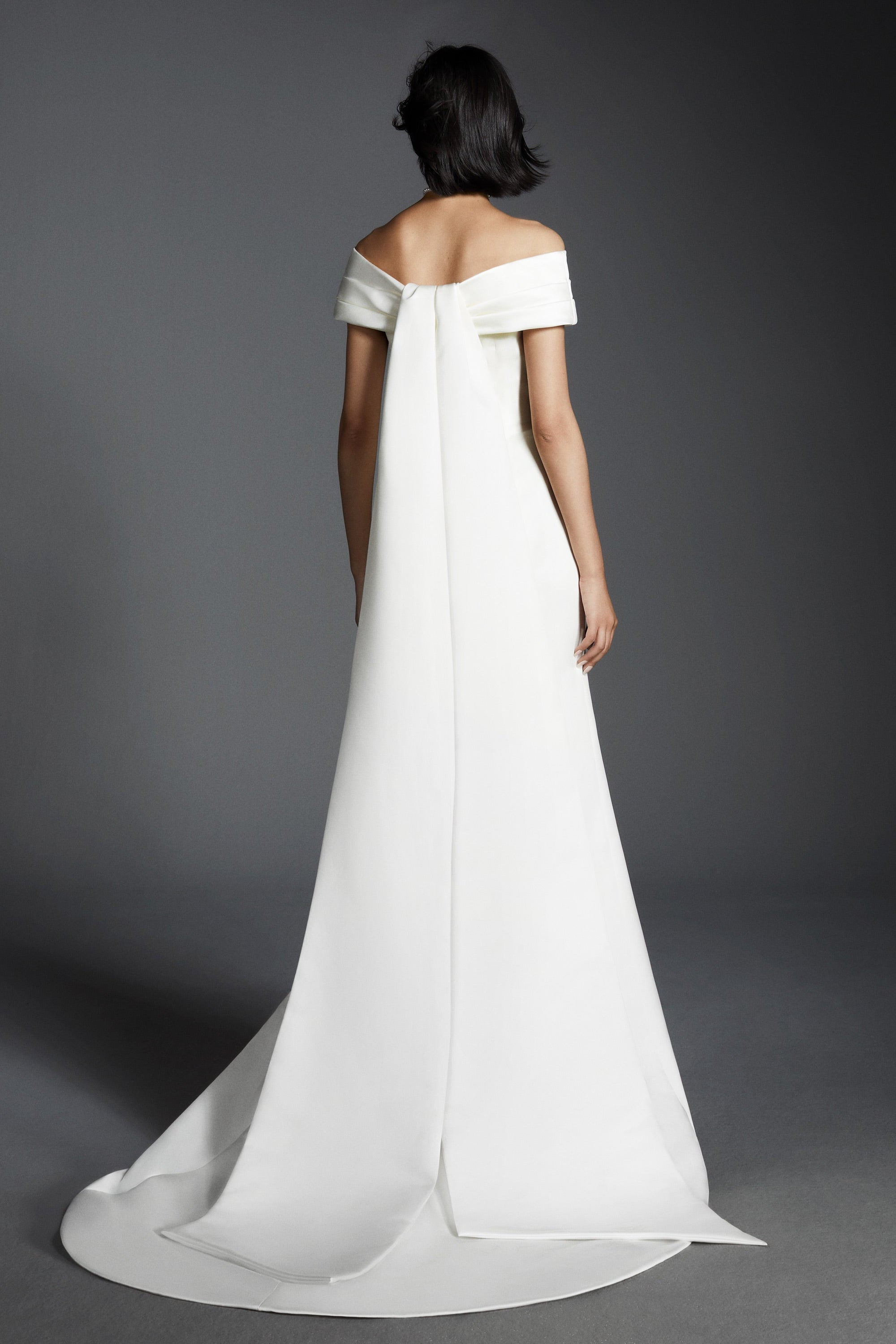 A charming mermaid gown, crafted out of satin, perfectly molds to the wearer’s body and flares out in a sweep train