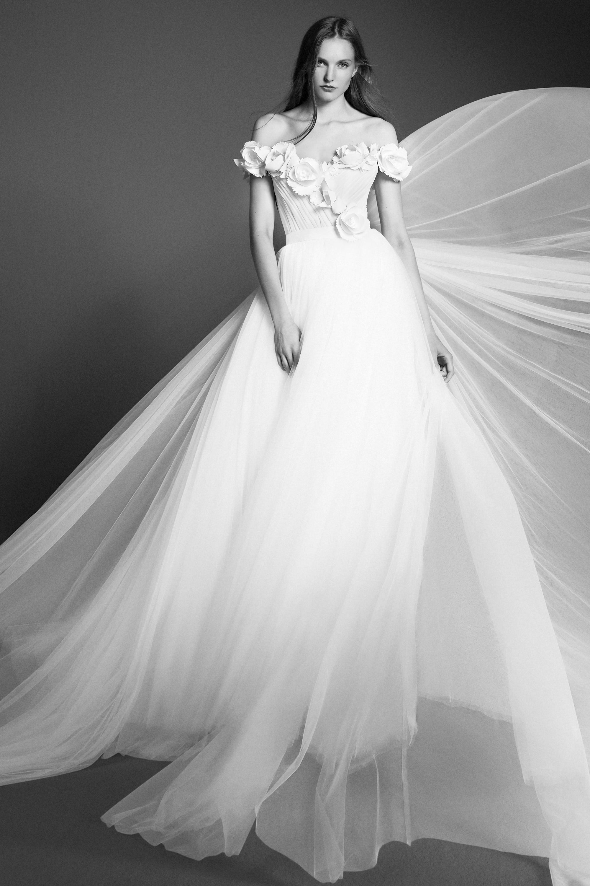 Dreamy tulle a-line gown featuring a bodice adorned with delicate garden flowers crafted from crepe