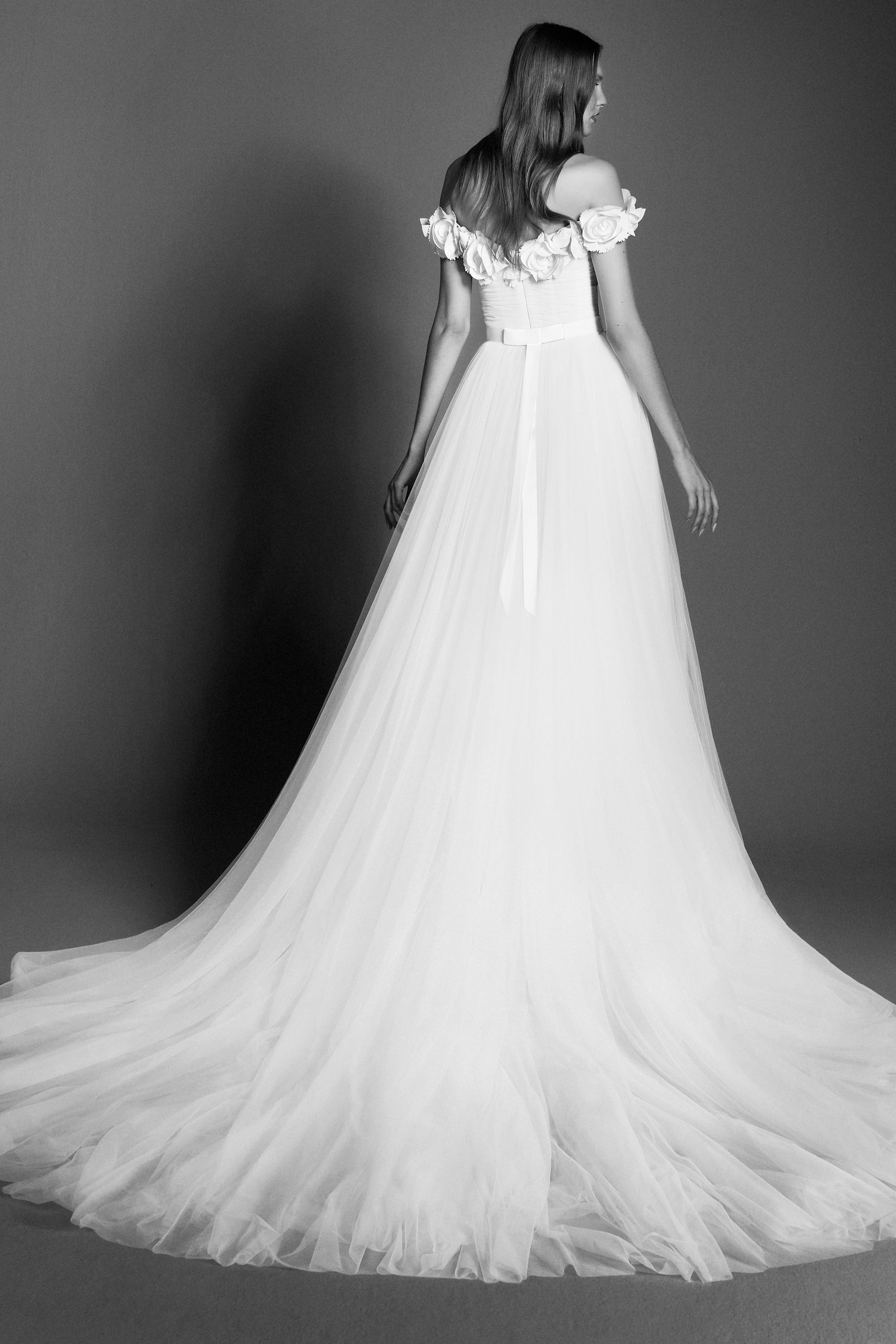 Dreamy tulle a-line gown featuring a bodice adorned with delicate garden flowers crafted from crepe