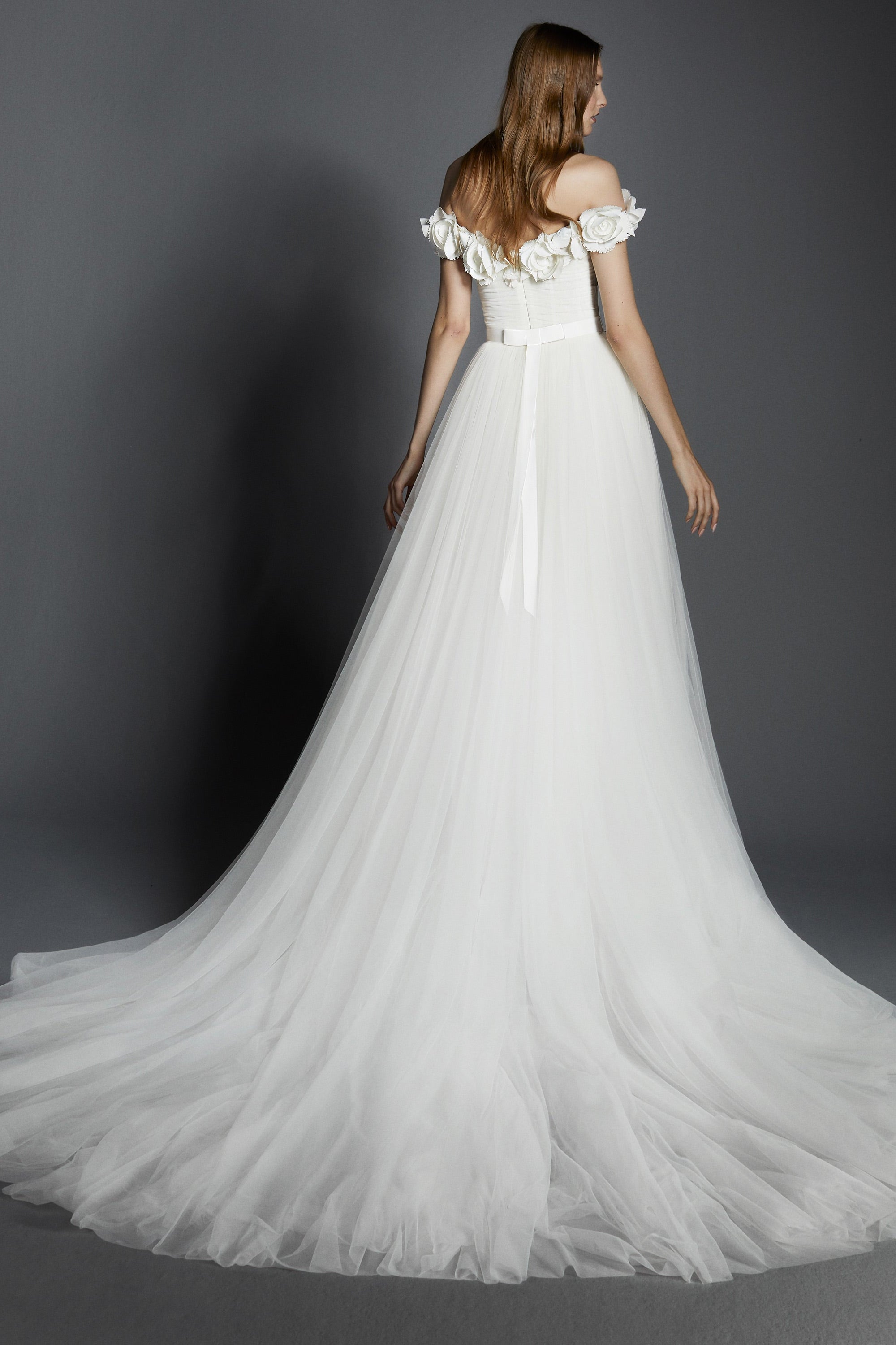 Dreamy tulle a-line gown featuring a bodice adorned with delicate garden flowers crafted from crepe