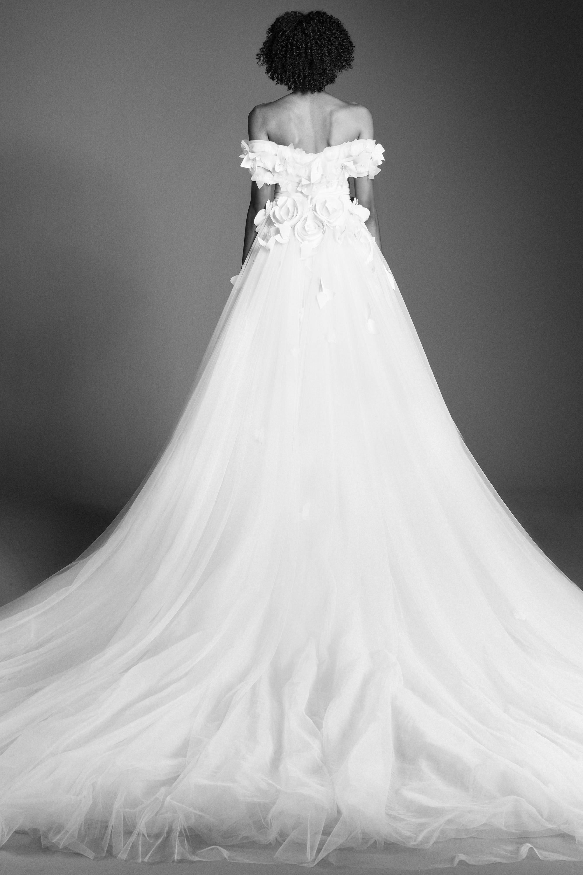 Featuring a tulle skirt paired with an airy organza bodice, this ballgown is complemented by an elegant sweetheart neckline and off-shoulder sleeves