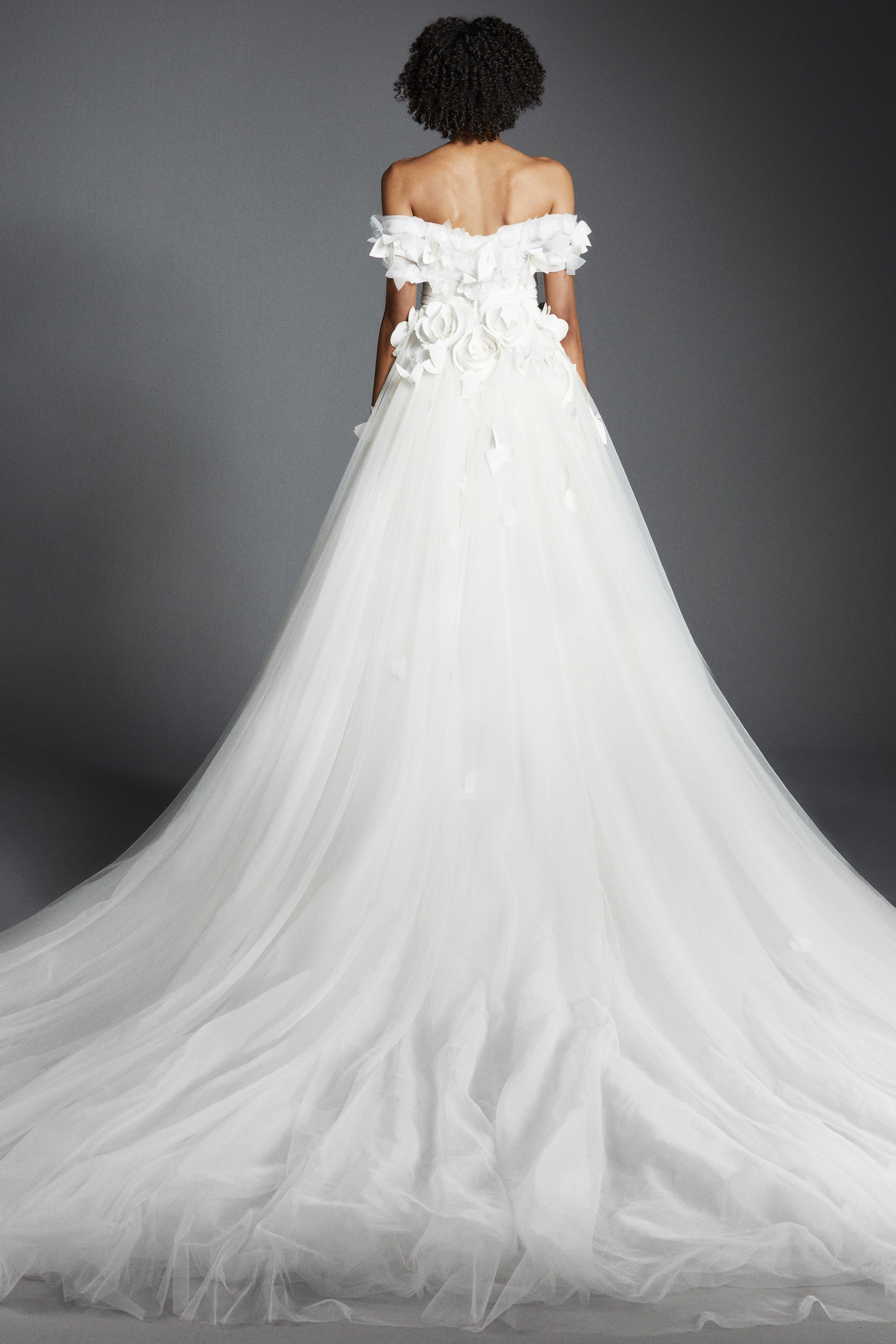 Featuring a tulle skirt paired with an airy organza bodice, this ballgown is complemented by an elegant sweetheart neckline and off-shoulder sleeves