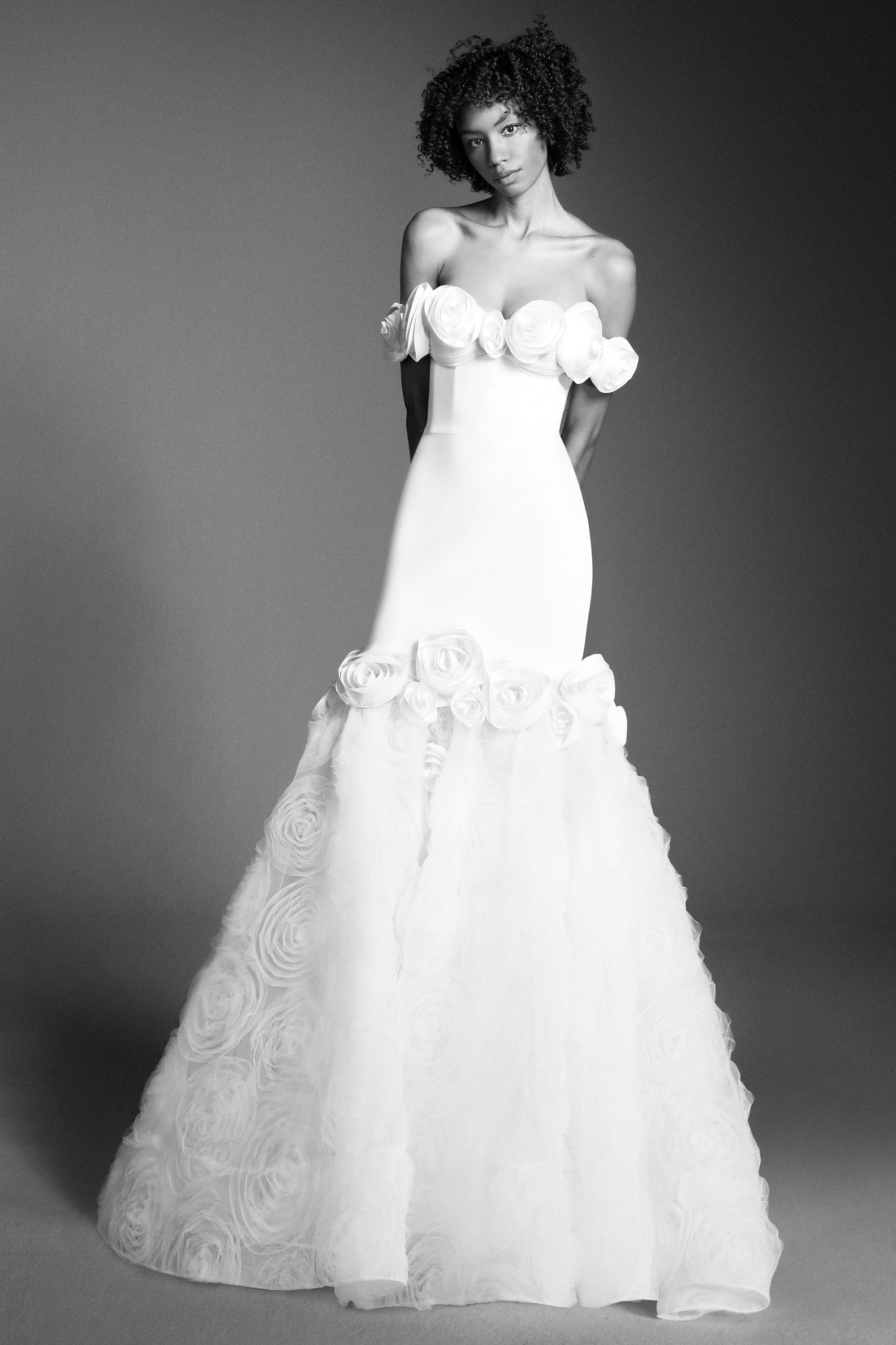 Elegant off-shoulder fit and flare silhouette, crafted from crepe with a slight stretch that sculpts the wearer's body