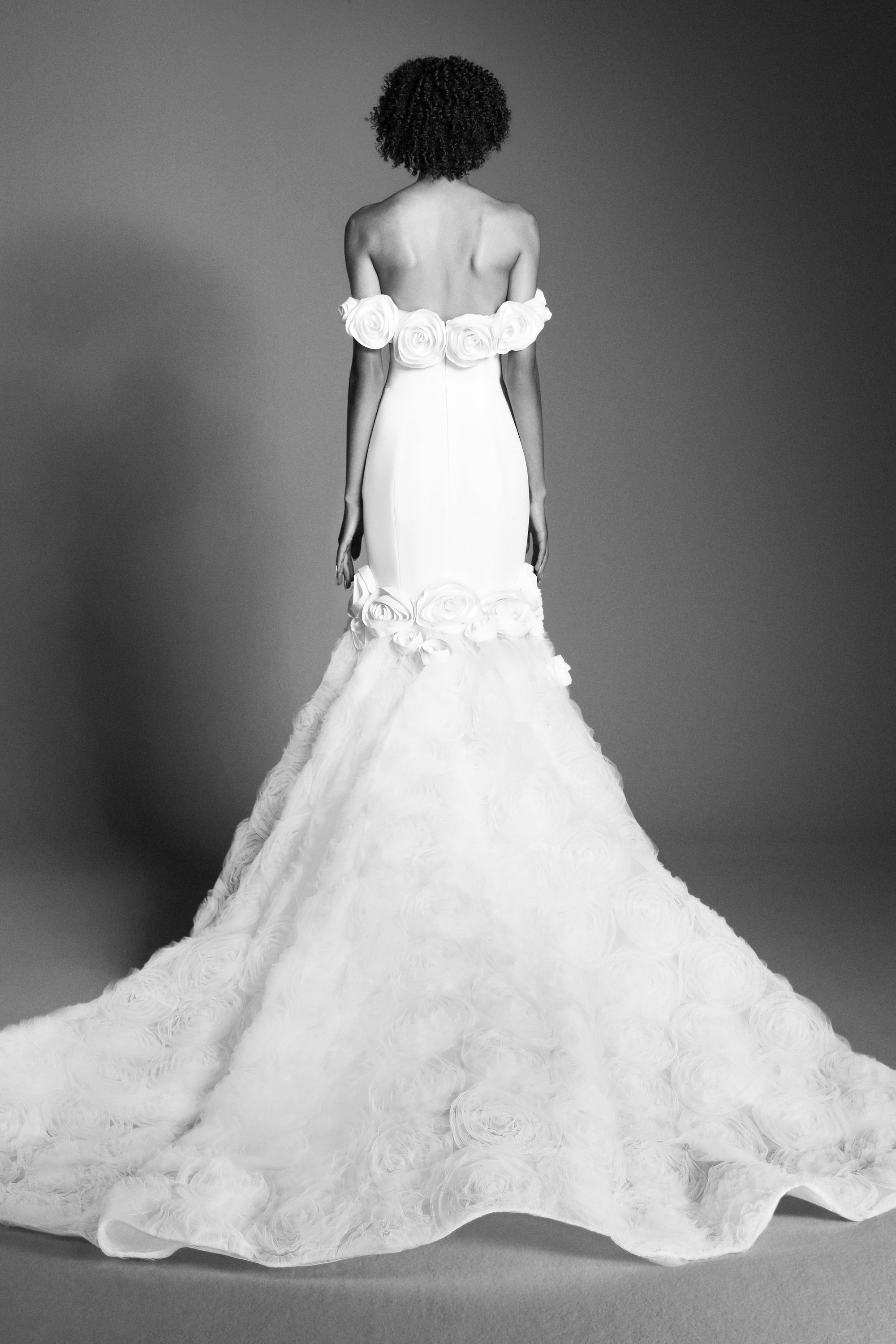 Elegant off-shoulder fit and flare silhouette, crafted from crepe with a slight stretch that sculpts the wearer's body