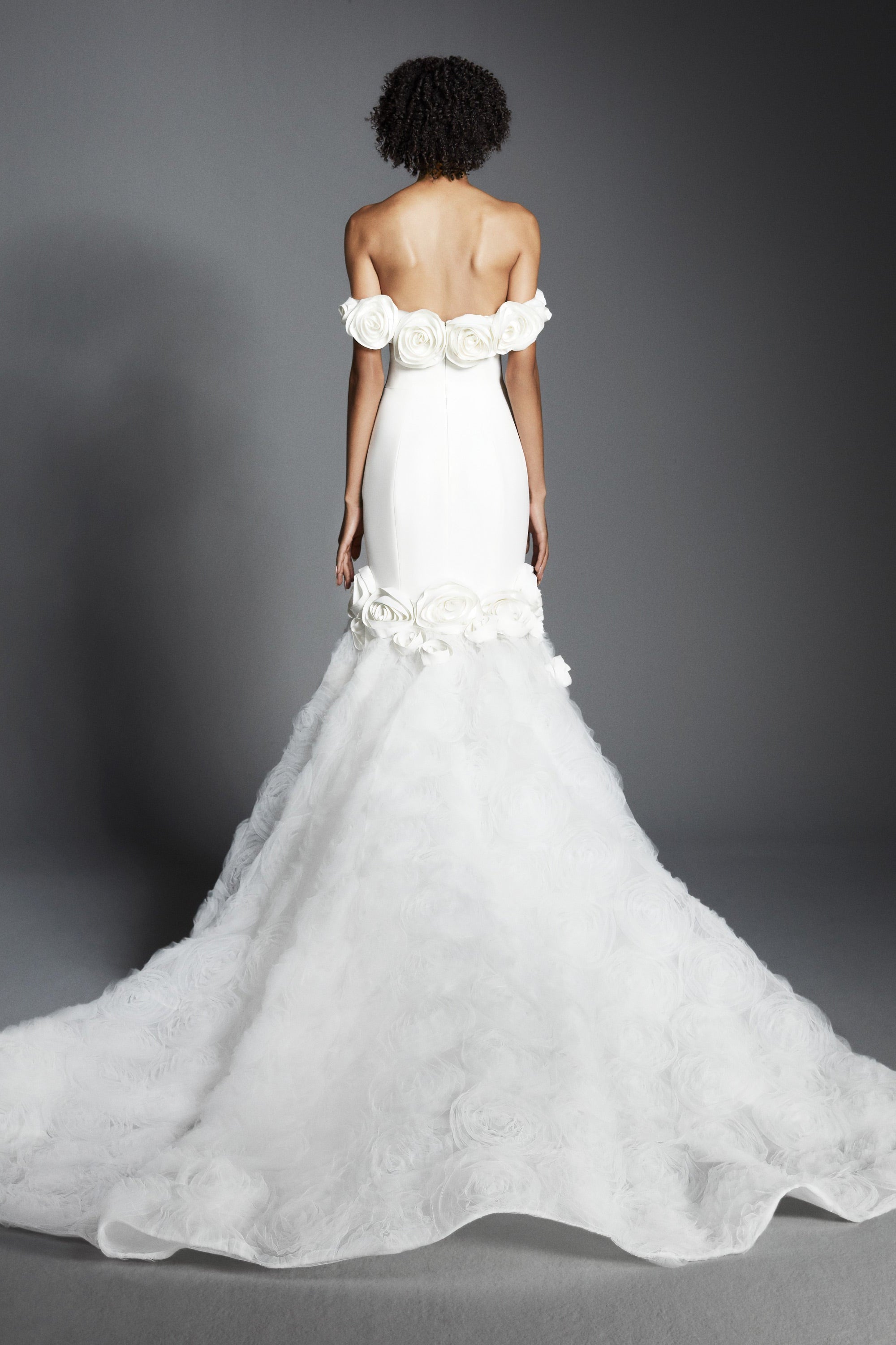 Elegant off-shoulder fit and flare silhouette, crafted from crepe with a slight stretch that sculpts the wearer's body