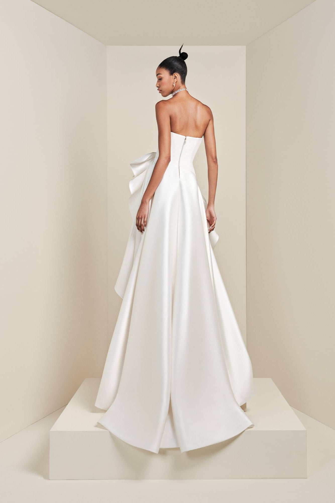 Crafted from a blend of stretch crepe and mikado, this sophisticated gown boasts a sweetheart bustier that beautifully enhances a clean column silhouette