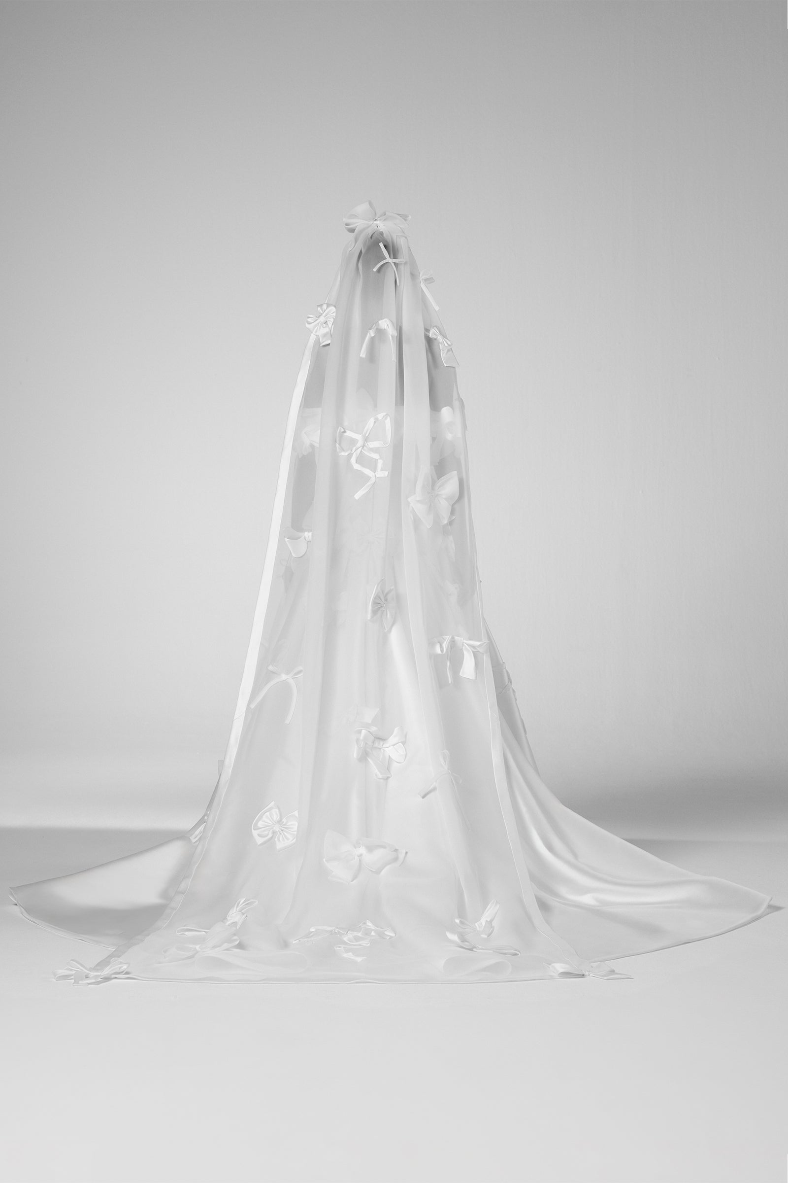 A dramatic organza veil adorned with an abundance of bows crafted from mikado, satin, and organza, from the Viktor&Rolf Mariage collection.