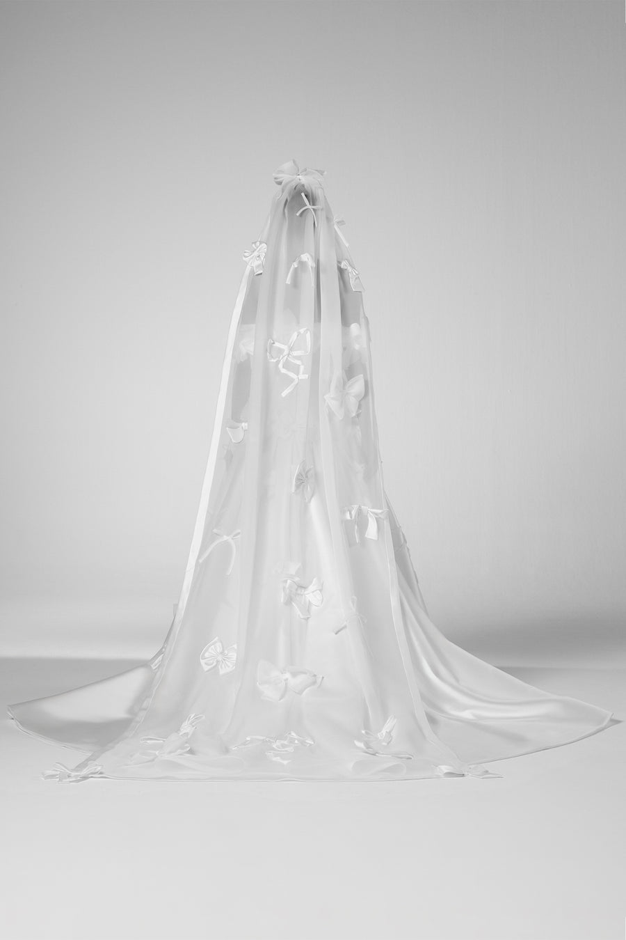 A dramatic organza veil adorned with an abundance of bows crafted from mikado, satin, and organza, from the Viktor&Rolf Mariage collection.