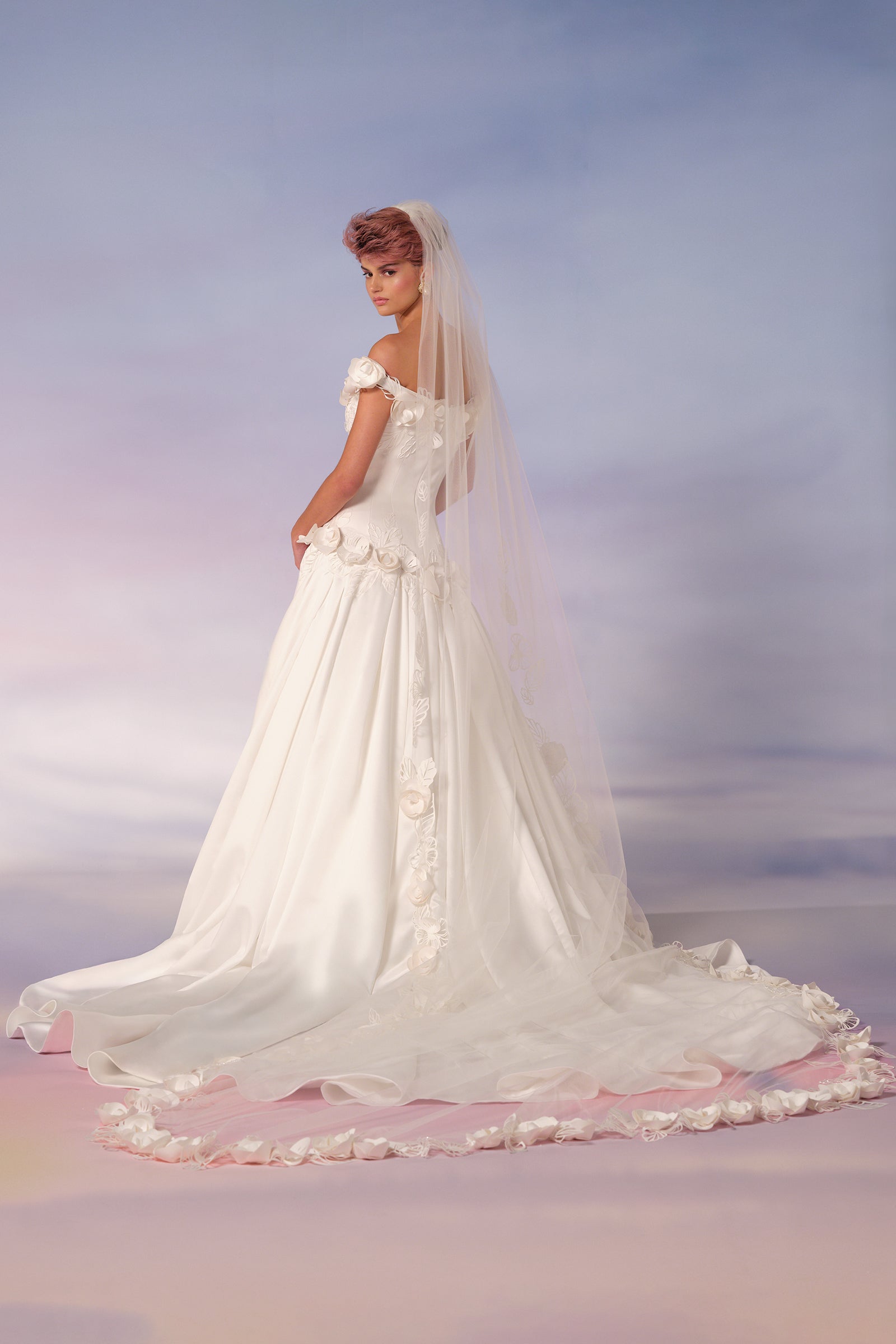 This dramatic tulle veil is adorned with an intricate garden of lace pansies crafted in bonded satin, from the Viktor&Rolf Mariage collection.