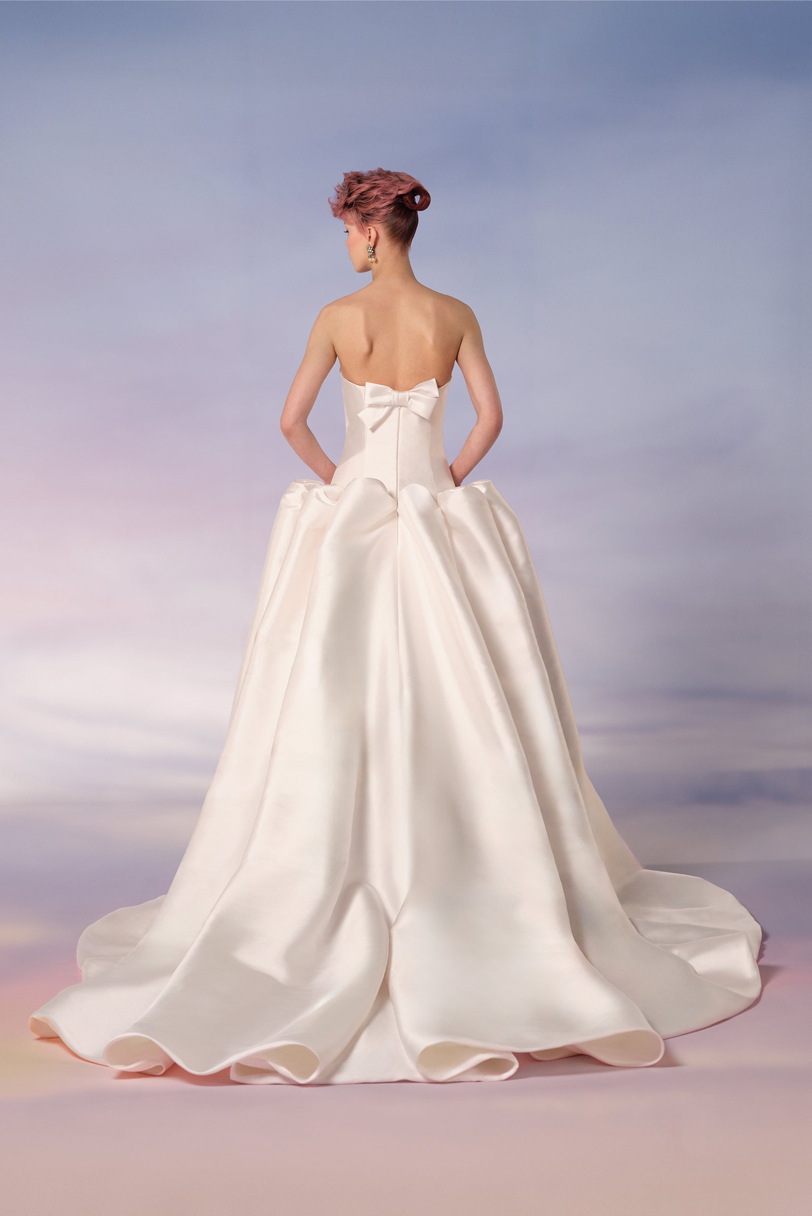 Crafted in mikado, this a-line gown features bold sculptural puffs at the dropped waist, from the Viktor&Rolf Mariage collection.