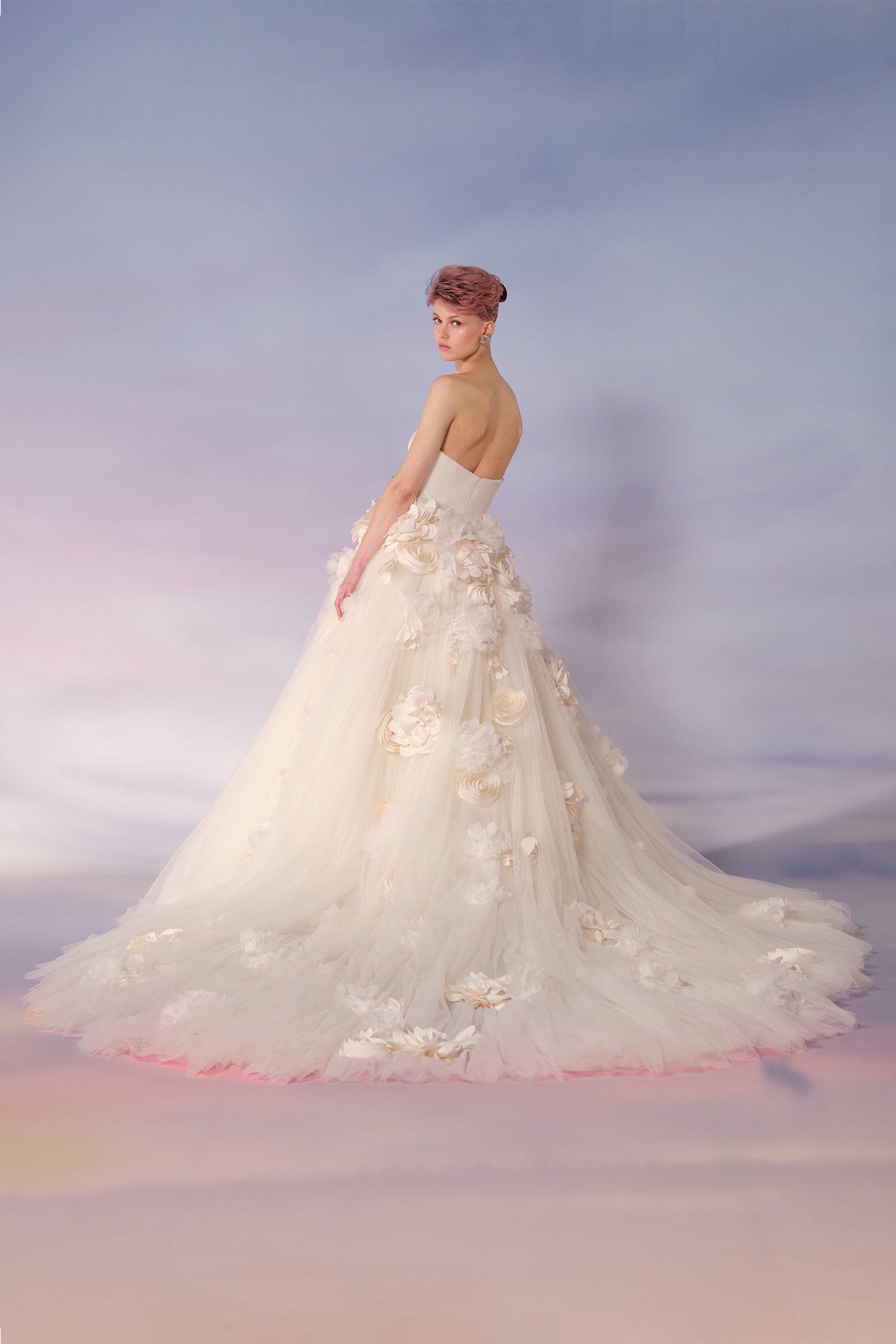 This strapless ball gown features a sleek stretch crepe strapless bodice, and a dramatically voluminous tulle skirt, from the Viktor&Rolf Mariage collection.