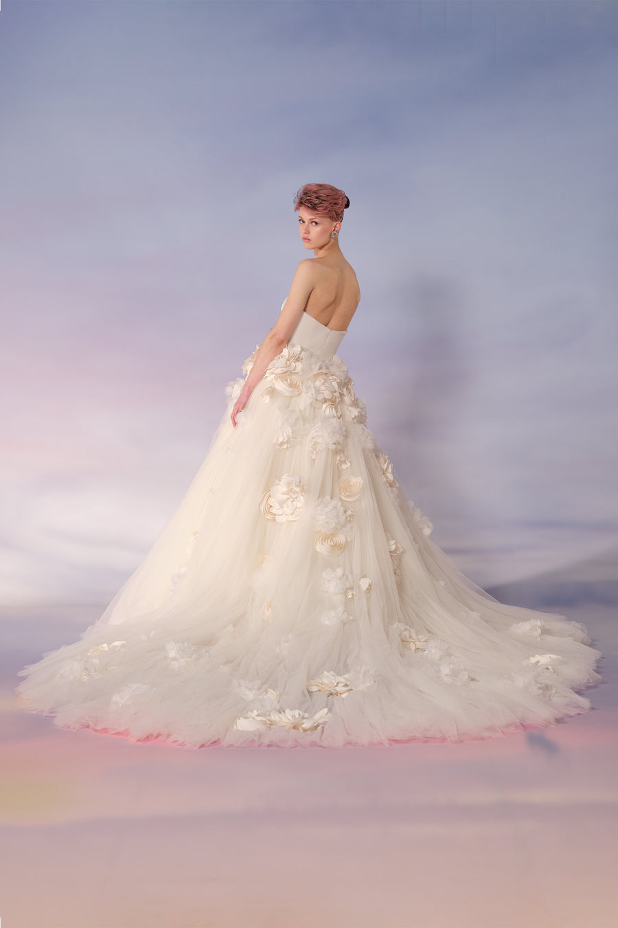 This strapless ball gown features a sleek stretch crepe strapless bodice, and  a dramatically voluminous tulle skirt, from the Viktor&Rolf Mariage collection.