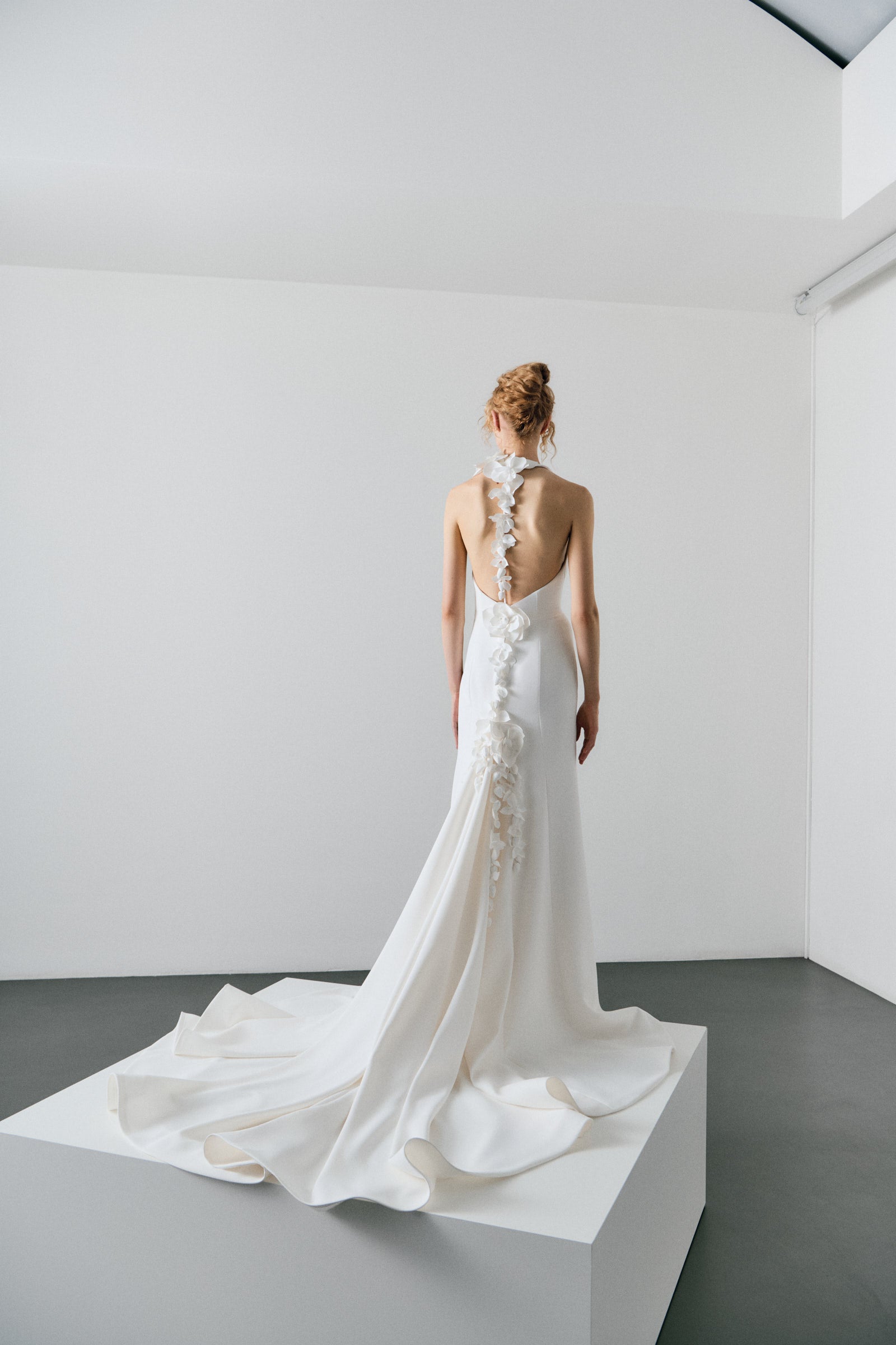 White wedding dress on a model against a plain white background