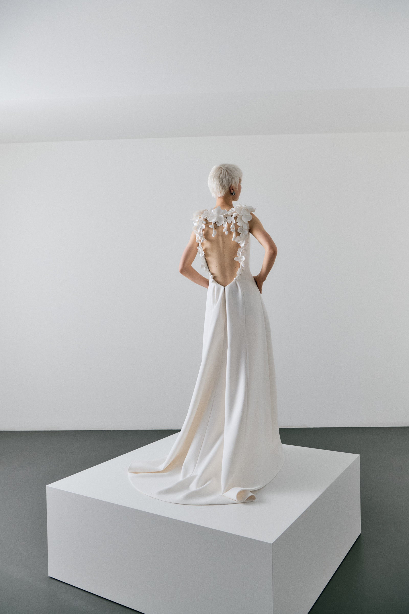 White wedding dress on a model against a plain background