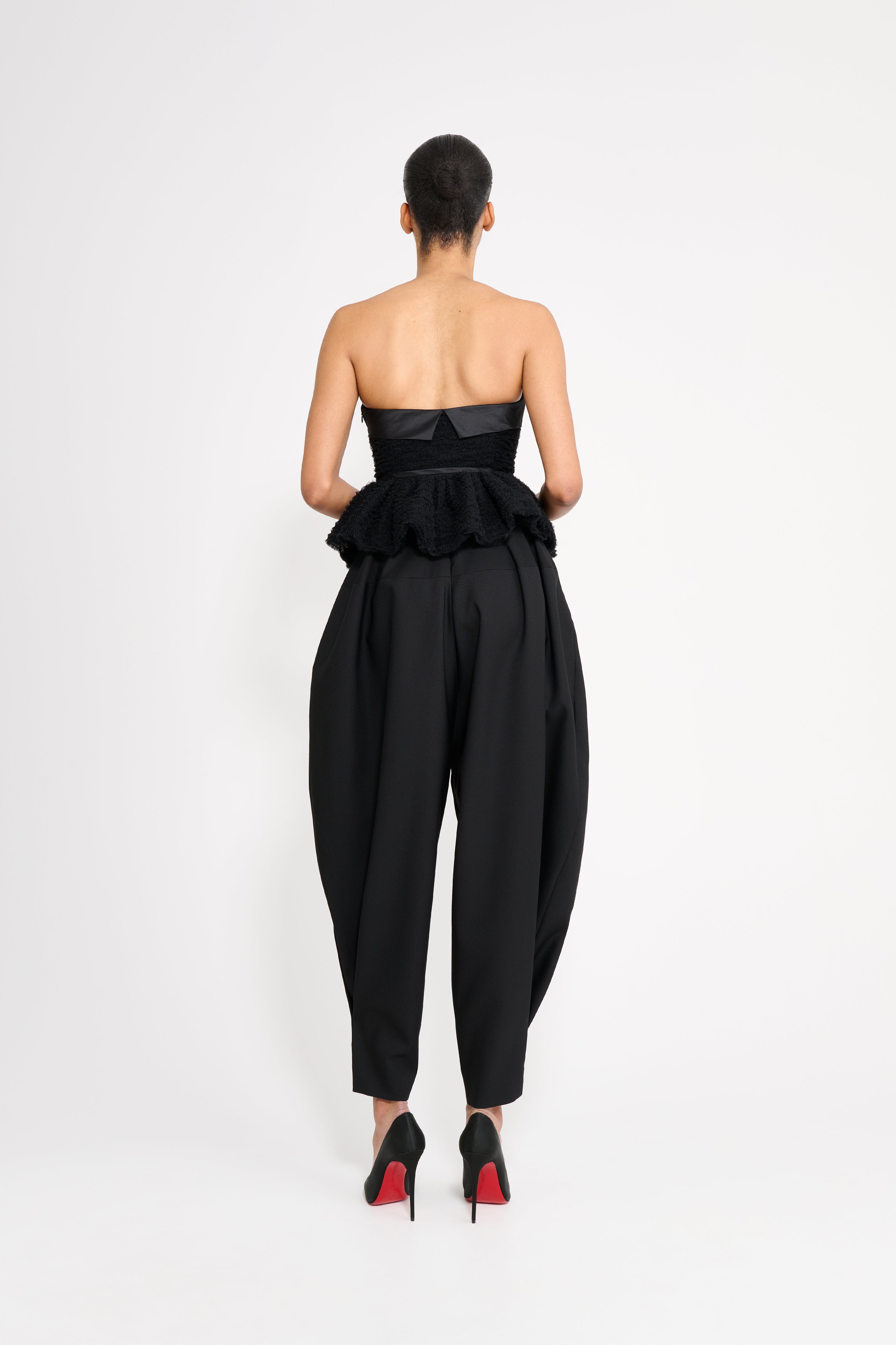 Woman wearing a black top on a white background