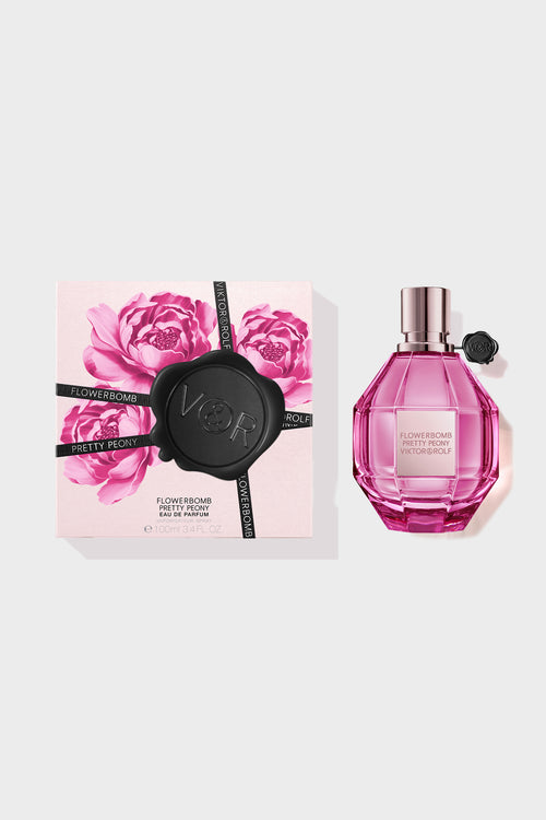 Pretty Peony Flowerbomb perfume in a pink bottle with a box next to it on a white background.