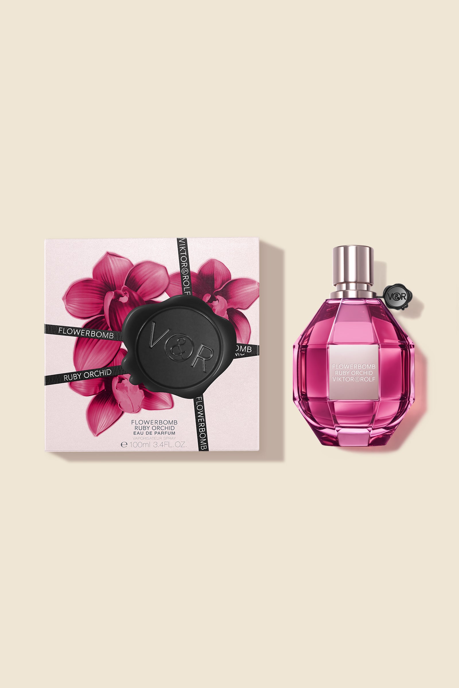 A faceted pink bottle of Flowerbomb fragrance by Viktor & Rolf, designed for women, with a chic and modern finish.