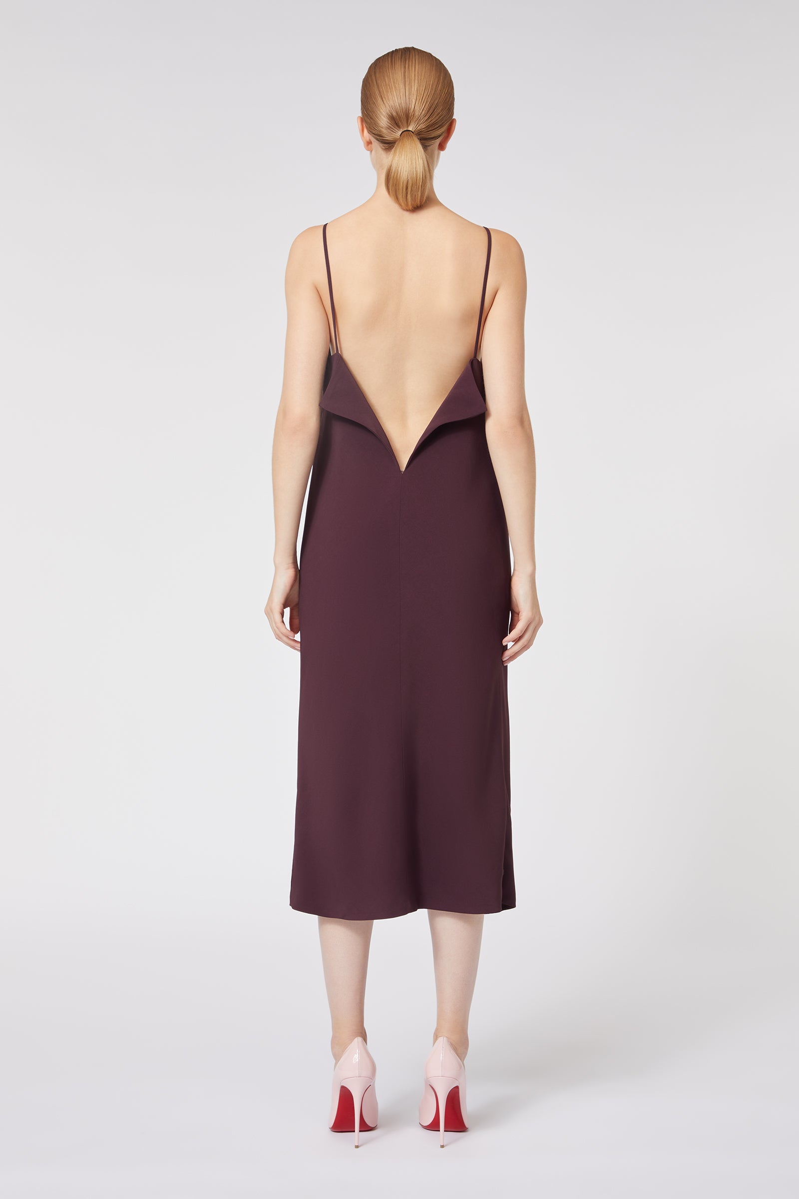 Backless wine silk dress with delicate spaghetti straps, featuring a unique avant-garde geometric V-shaped back design.