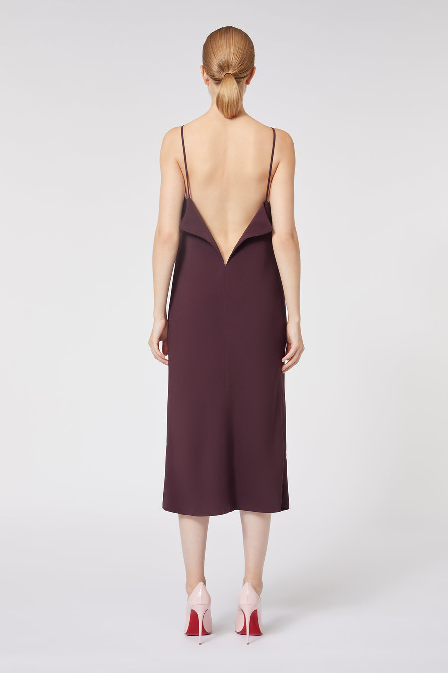 Backless wine silk dress with delicate spaghetti straps, featuring a unique avant-garde geometric V-shaped back design.