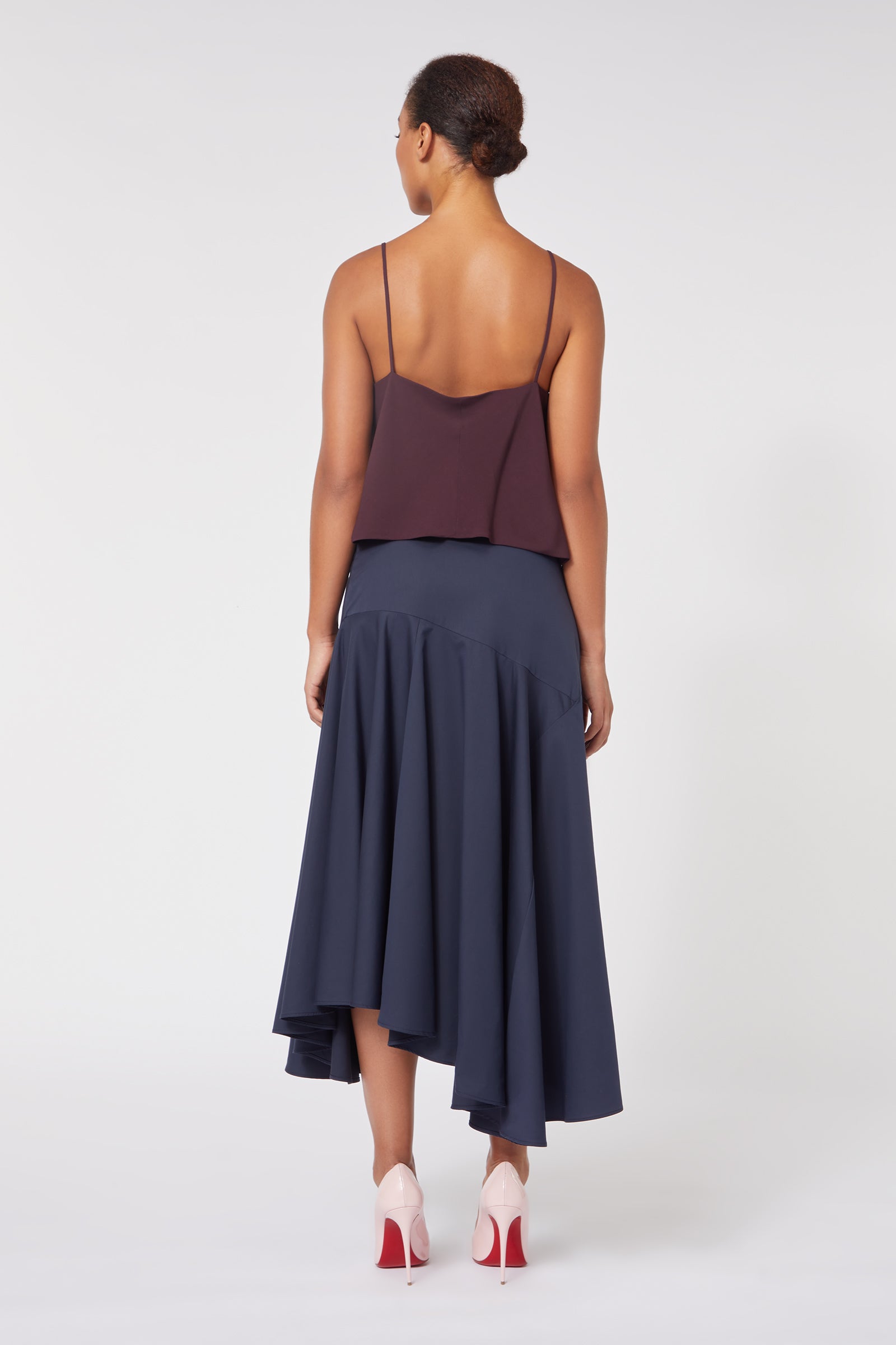Elegant wine camisole with a navy asymmetrical skirt, showcasing a sophisticated contrast of colors and textures.