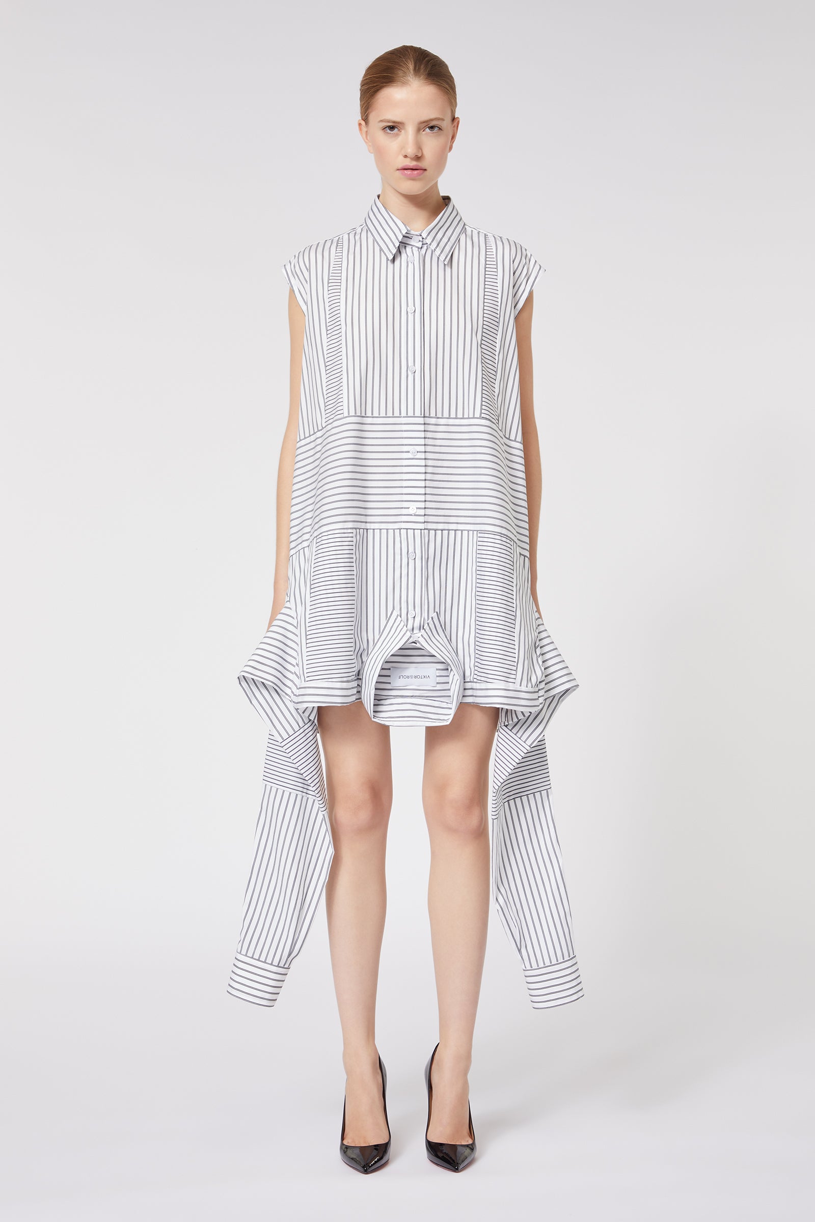 Striped shirt dress with asymmetric hemline, featuring a tailored collar and cap sleeves, crafted from lightweight fabric.