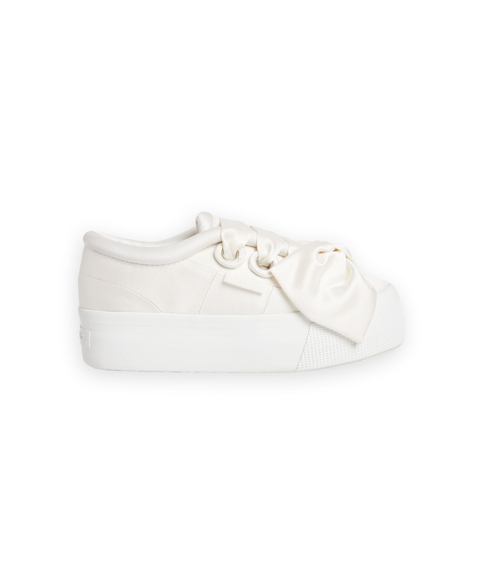 Platform sneaker featuring a soft ivory satin finish and oversized bow detail, emphasizing contemporary casual elegance.