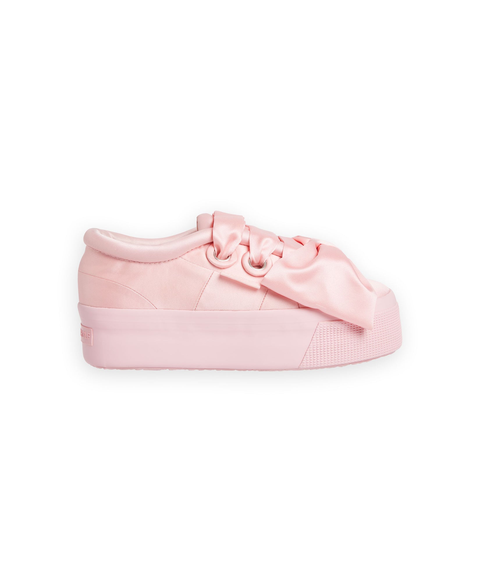 A blush pink satin sneaker with oversized ribbon laces, featuring a thick platform sole for a chic, modern look.