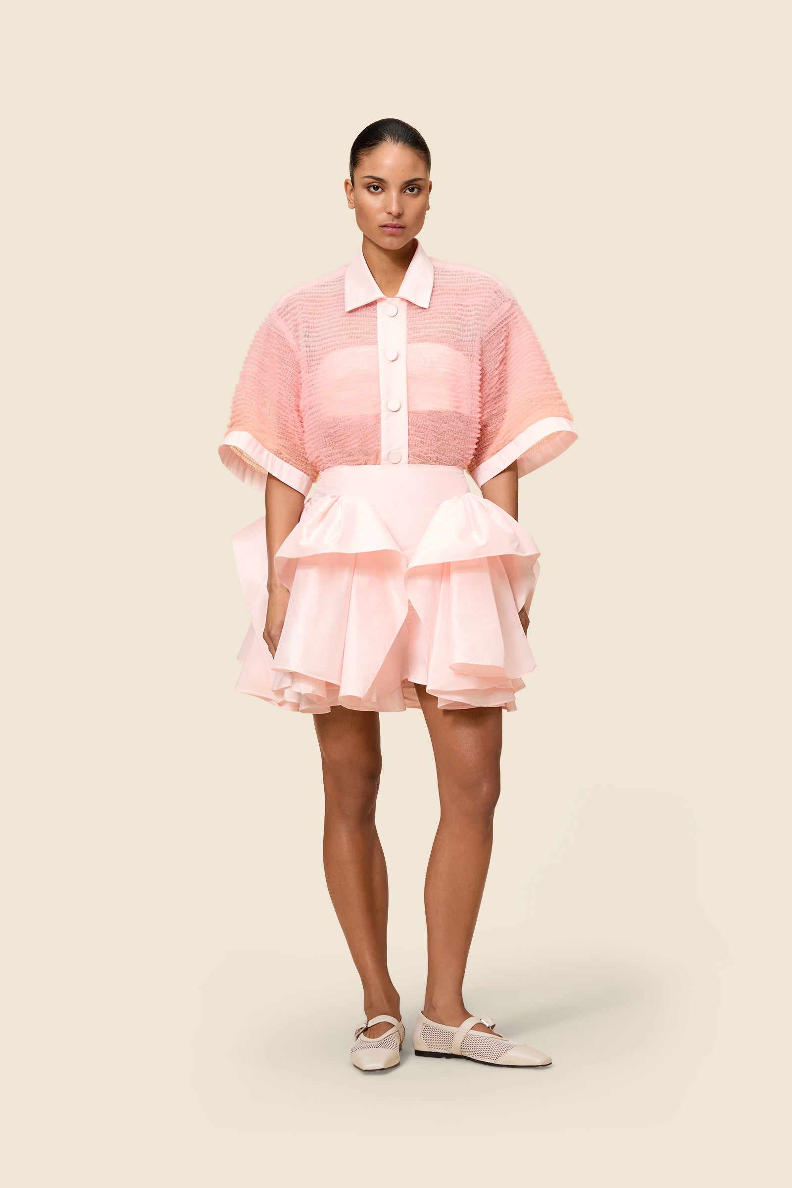 The craftmanship of the skirt reinterprets classic haute couture tuck ups into a modern silhouette from silk-blend taffeta