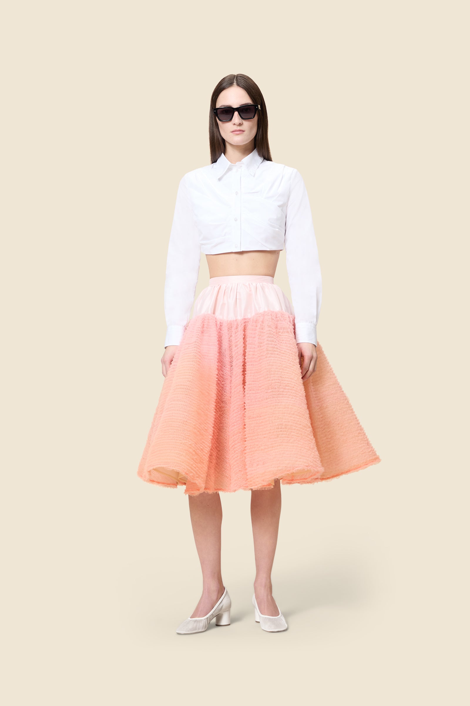 Inspired by the tulle from the ‘late stage capitalism waltz’ haute couture collection, the skirt features hand crafted tulle ruffles for a feminine texture