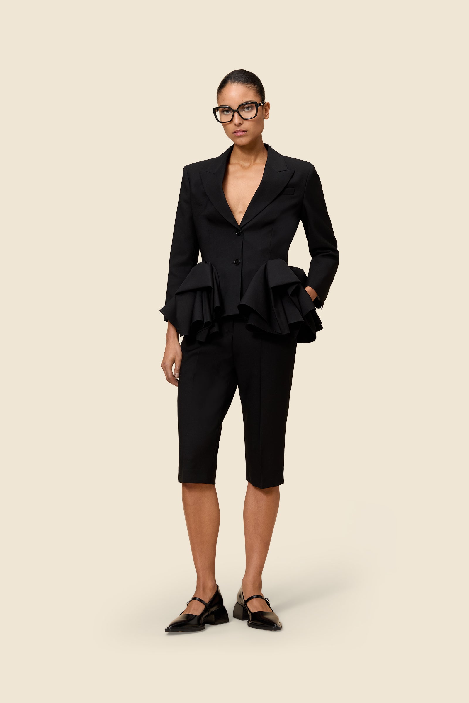 Crafted from wool, the high-waisted capri pant offers a tailored fit and timeless elegance