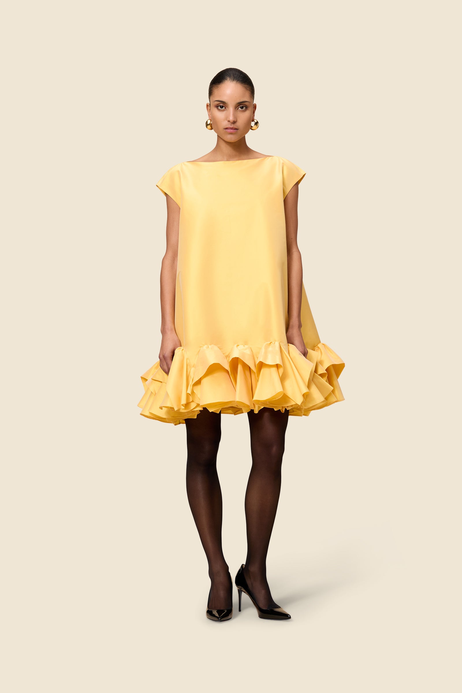 The craftmanship of the dress reinterprets classic haute couture tuck ups into a modern silhouette from silk-blend taffeta