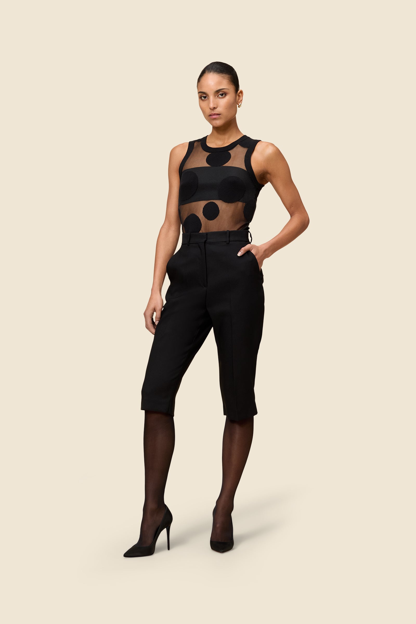 The classic pattern of the top is given a modern twist with intricate polka dot hole design on knit jacquard