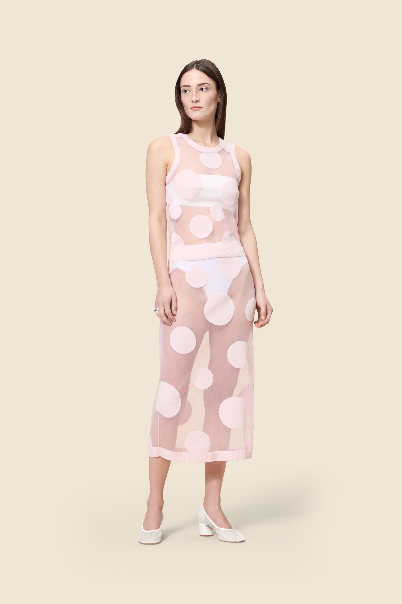 The classic pattern of the skirt is given a modern twist with intricate polka dot hole design on knit jacquard
