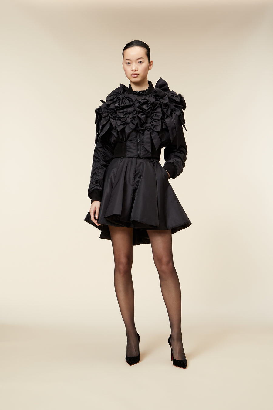 The bomber inspired by the haute couture "action dolls" collection reinvents playful sophistication, merging the volume of a puffer design with a seasonal bow bouquet technique