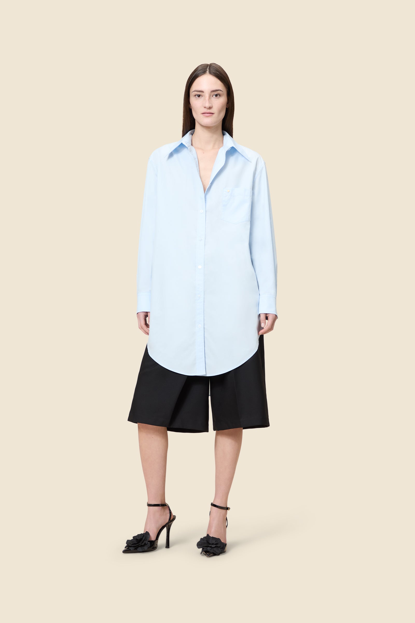 Crafted from poplin, the oversized shirt offers a tailored fit and timeless elegance