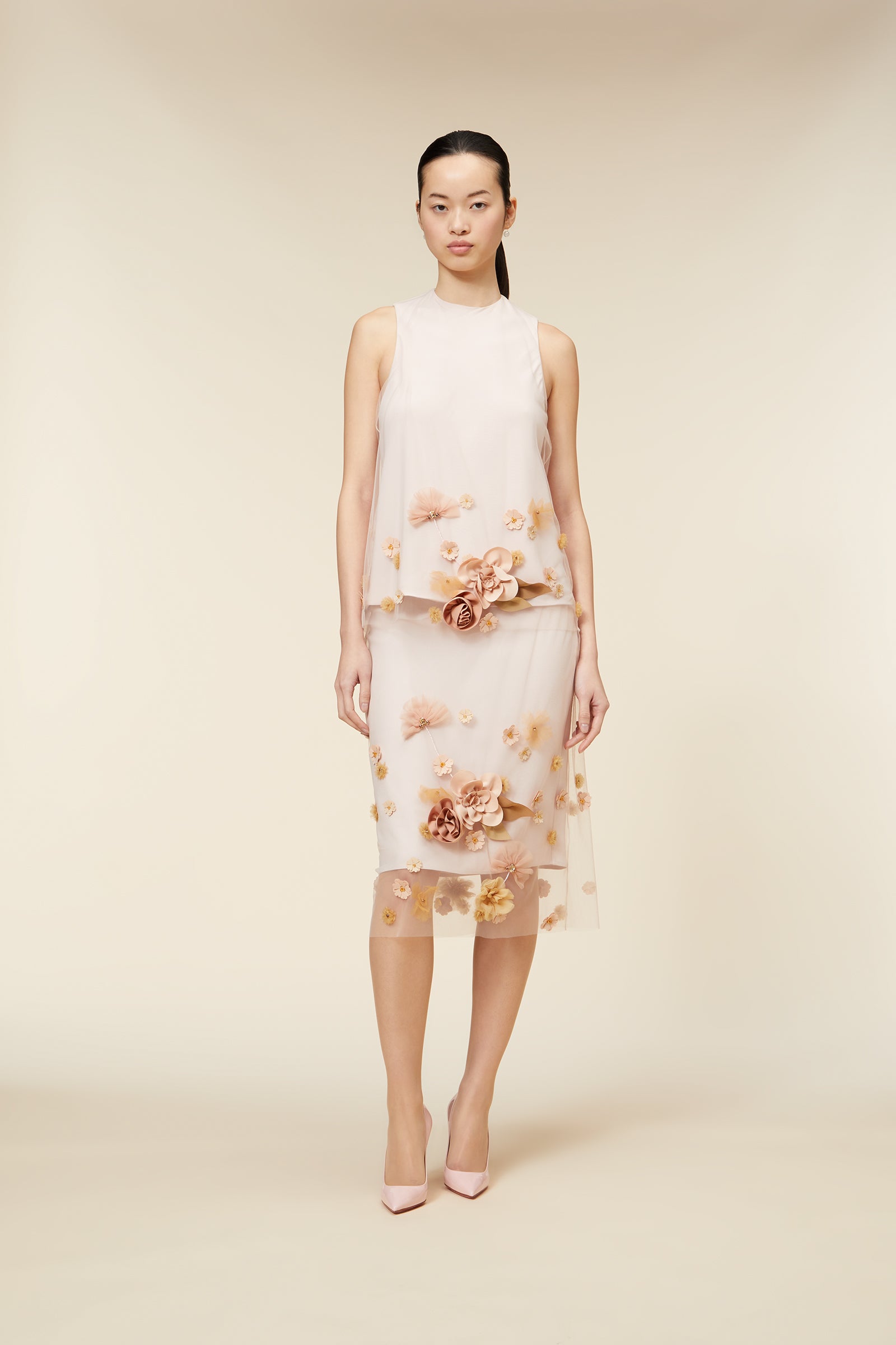 Delicate off-white floral embroidered dress with sheer overlay, featuring intricate 3D flower details, modeled on a plain background.