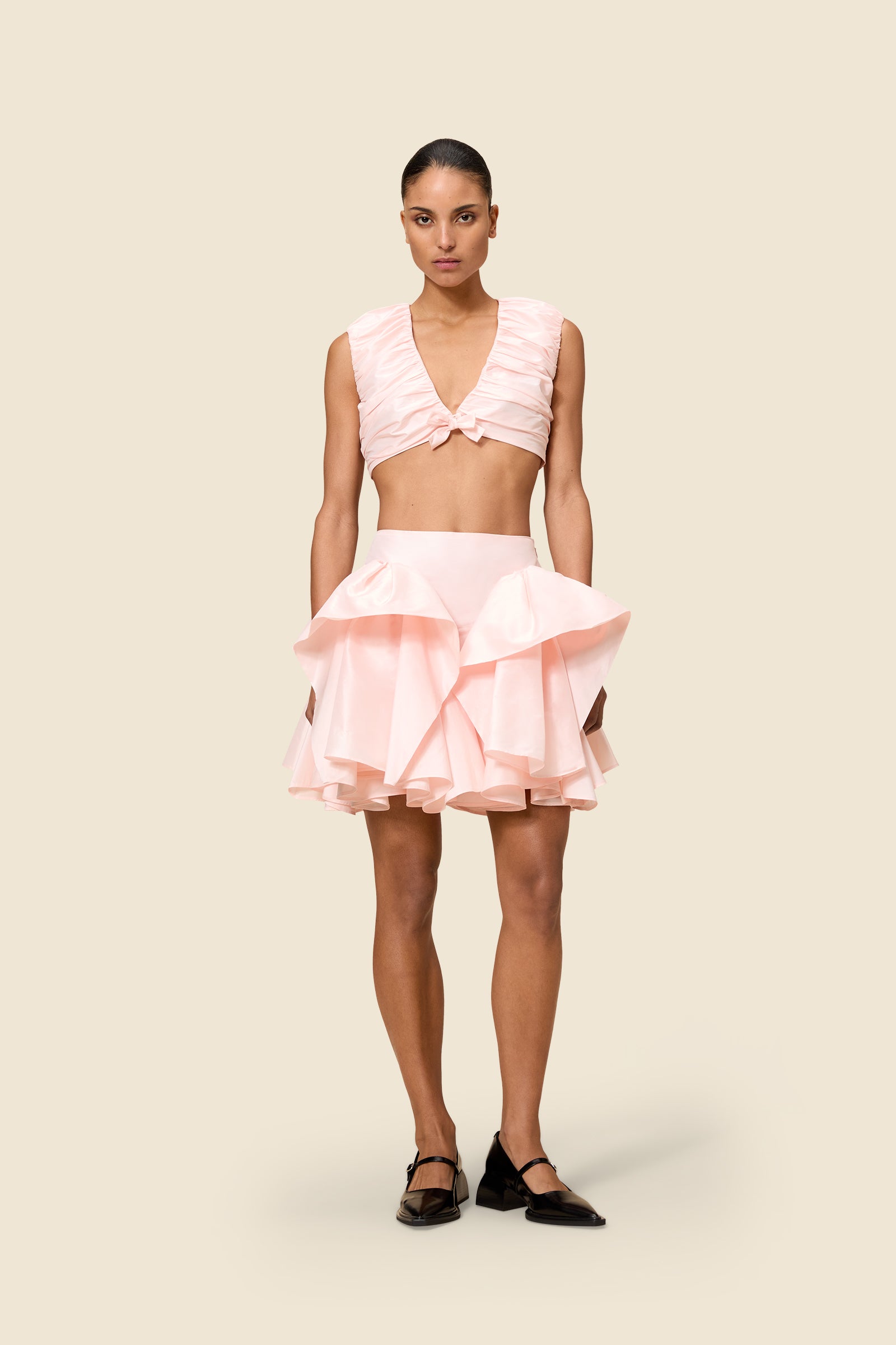 The meticulously placed pleats and silk-blend taffeta define the elegance of the top, reflecting classic haute couture craftsmanship with a modern edge