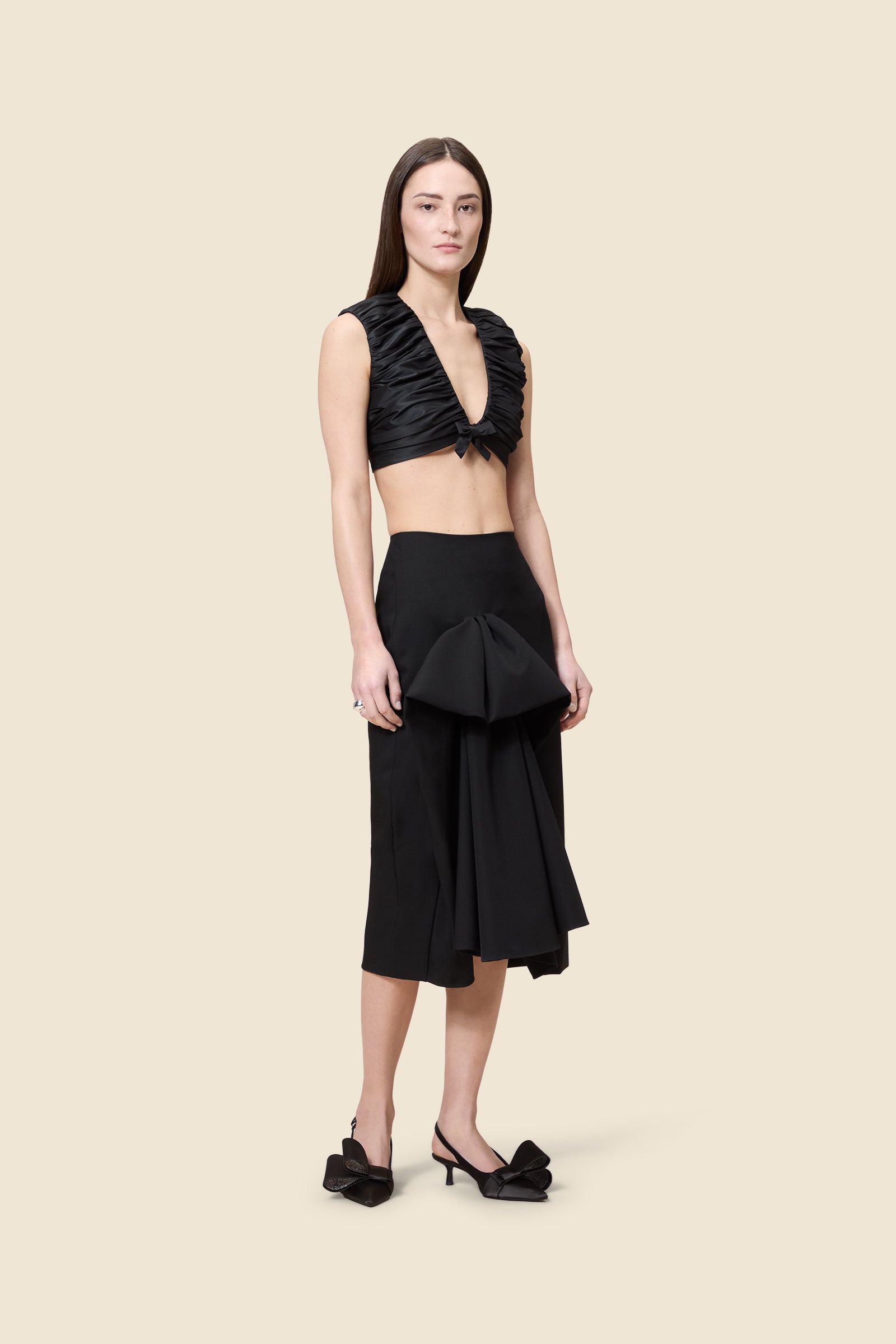 The meticulously placed pleats and silk-blend taffeta define the elegance of the top, reflecting classic haute couture craftsmanship with a modern edge