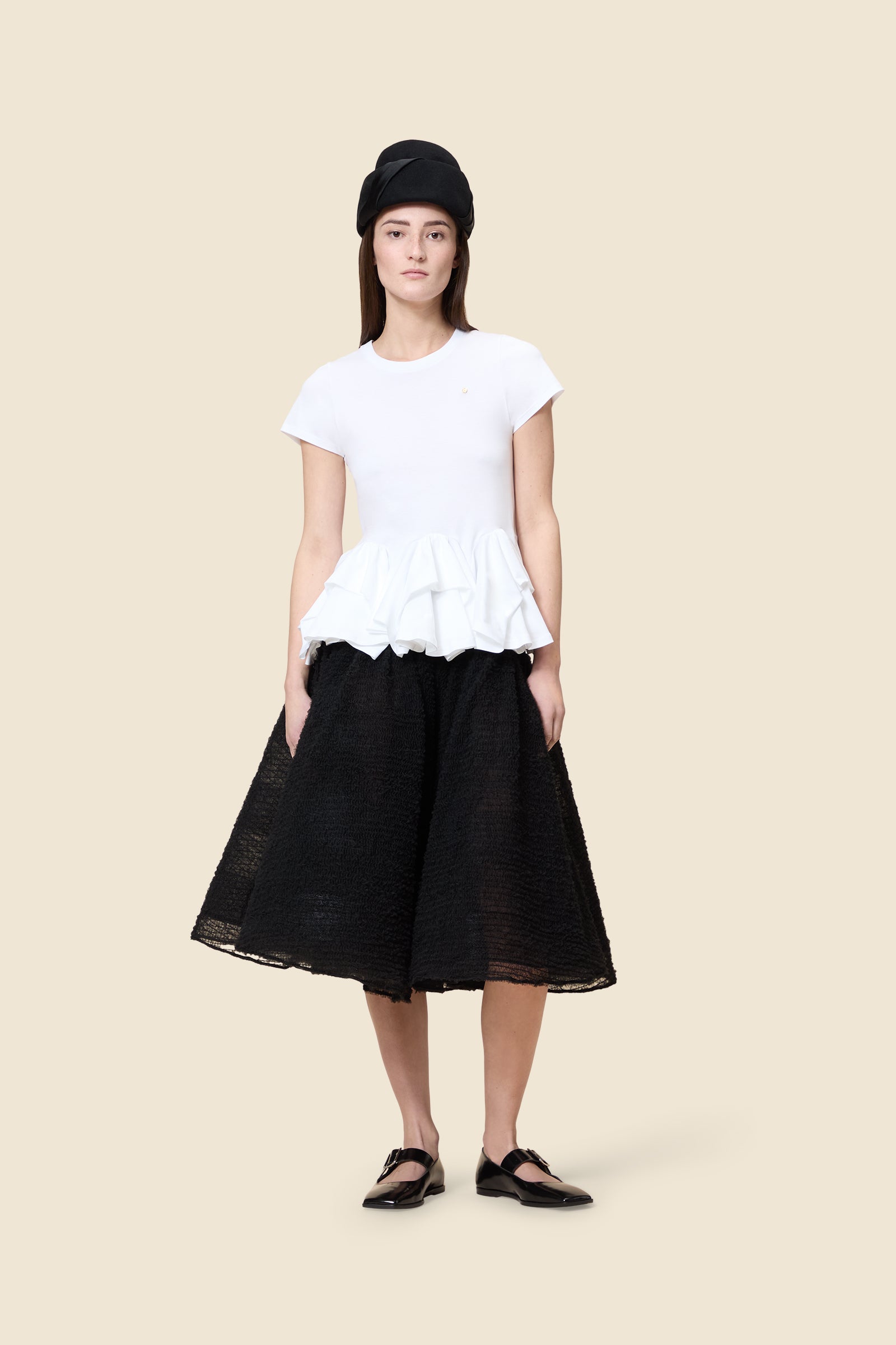 The craftmanship of the top reinterprets classic haute couture tuck ups into a modern silhouette