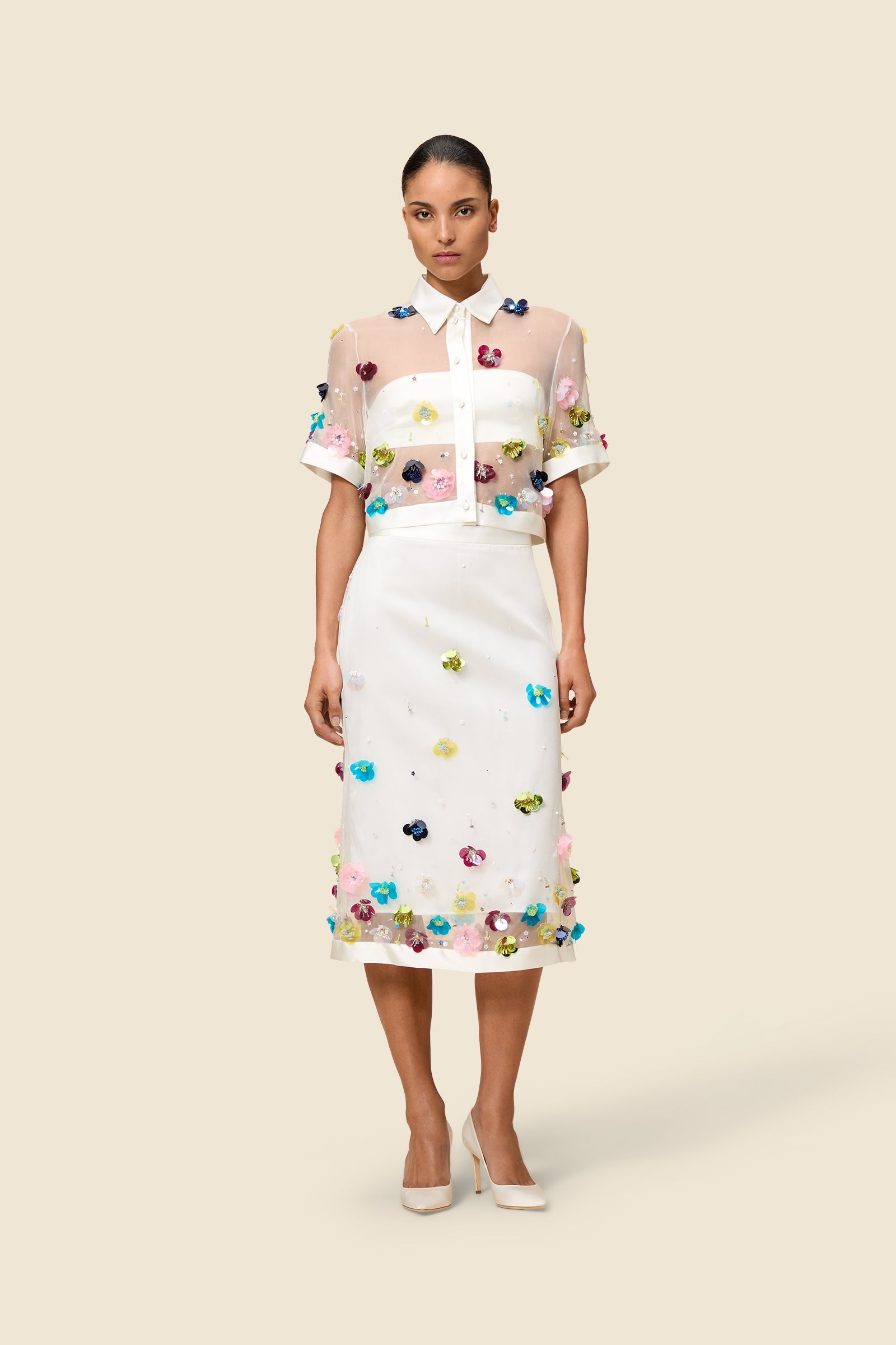 With hand-applied paillettes and crystals on silk organza featuring the satin edges, the skirt transforms classic floral embroidery into a modern piece